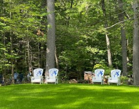 Lawn and outdoor chairs at 42 Cole Cottage, Belgrade, Maine.