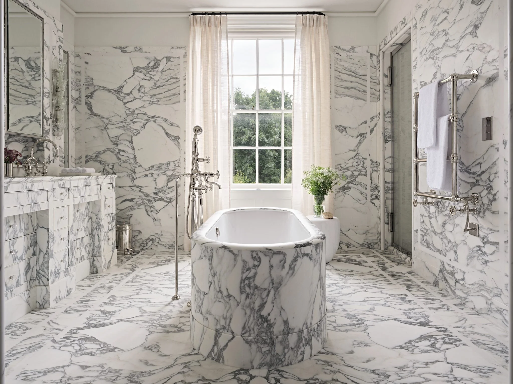 Contemporary marble bathroom with marble bath, interior design by Bryan O'Sullivan Studio