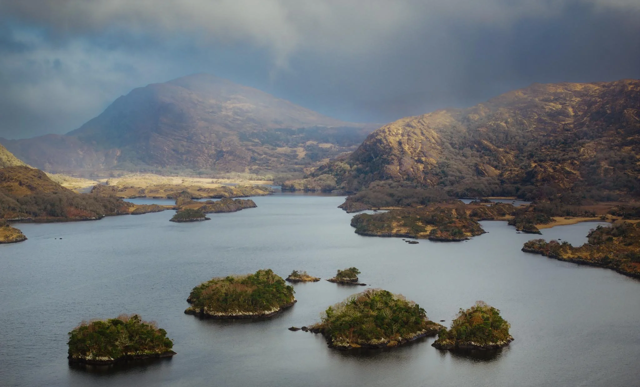 Drone photography of Killarney National Park Upper Lake in winter. Scenic landscape featuring the islands near Lord Brandon’s Cottage, Kerry mountains, and the Wild Atlantic Way hiking region in February.