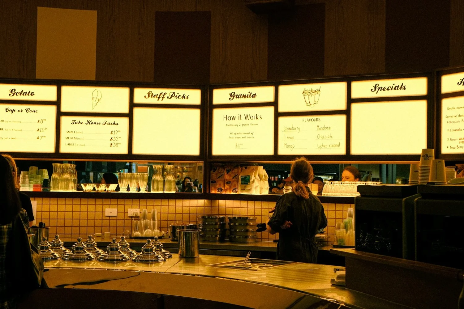Digital menu boards above a service counter