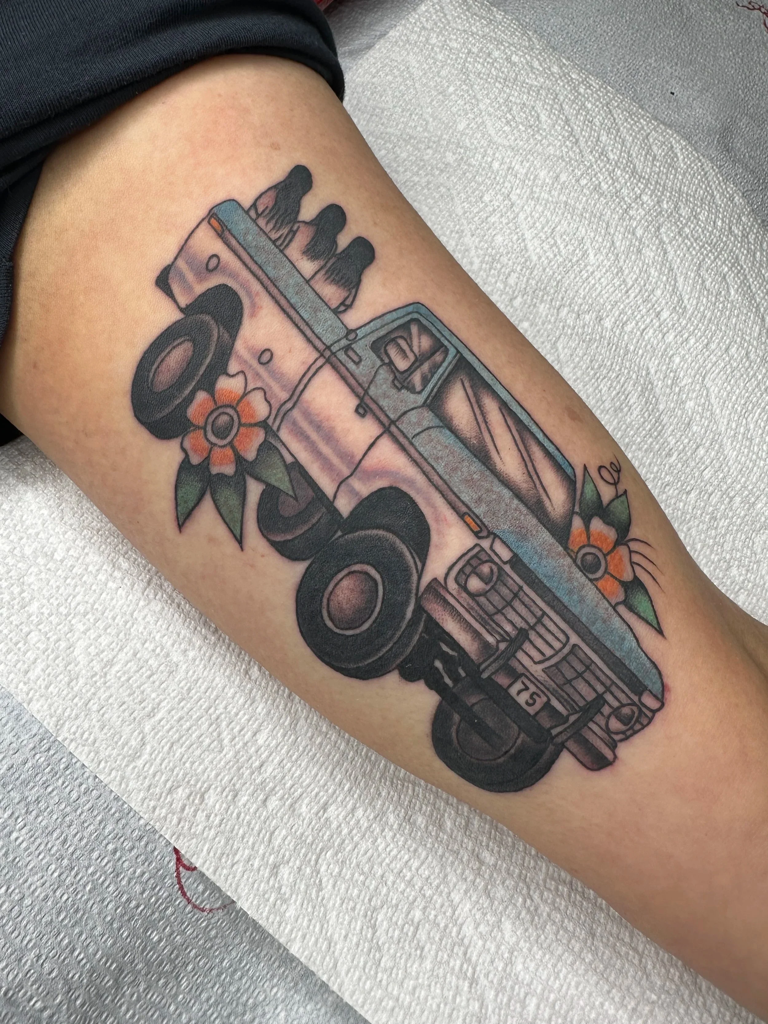 This traditional tattoo is of my client’s father’s truck with images of her sisters and her sitting in the back. He passed away and she wanted something to remember her time as a kid riding along in the truck and sitting in the back making memories