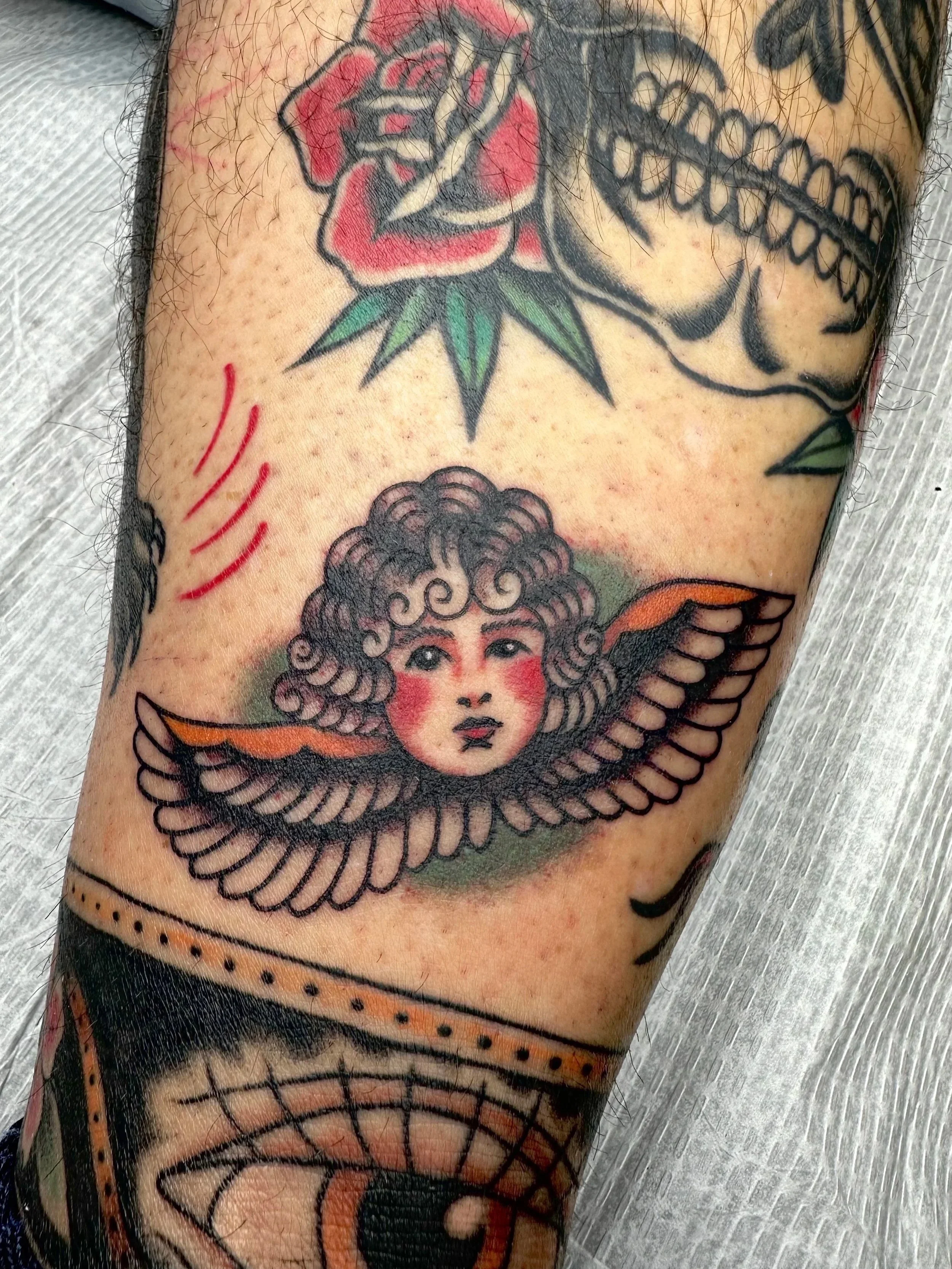 This American traditional angel tattoo is on one of my best clients. She saw a flash image on the wall at the shop and wanted something similar to fill a little space on the back of her leg.
