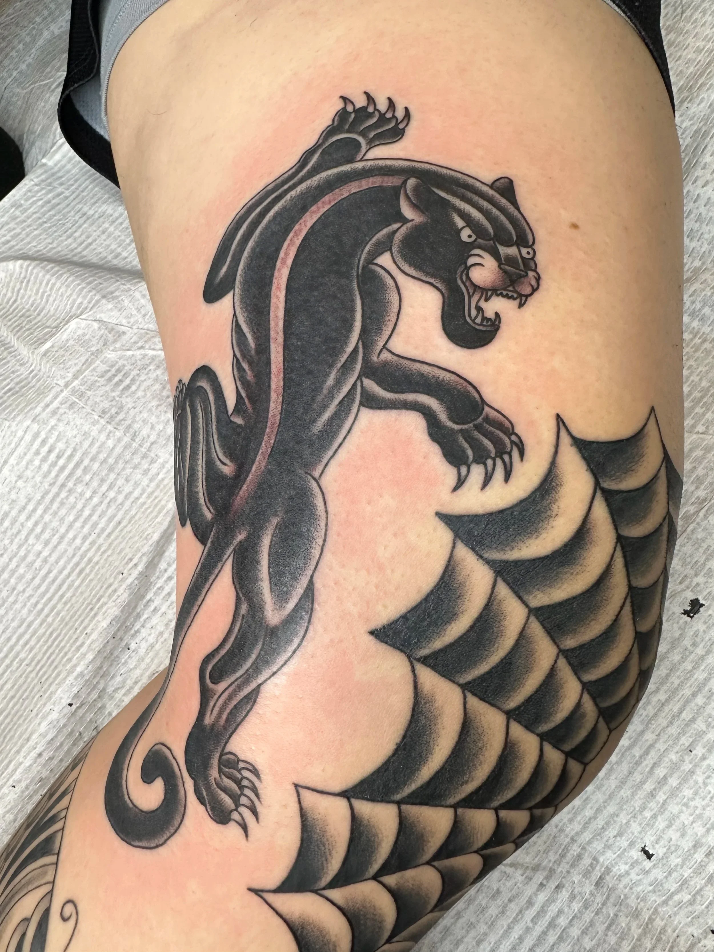 Traditional style black panther made for a client who decided he wanted his whole leg tattooed soup to nuts within the course of a few months as he was leaving the military and wanted to move. He sent me images of classic tattoos he wanted and I redr