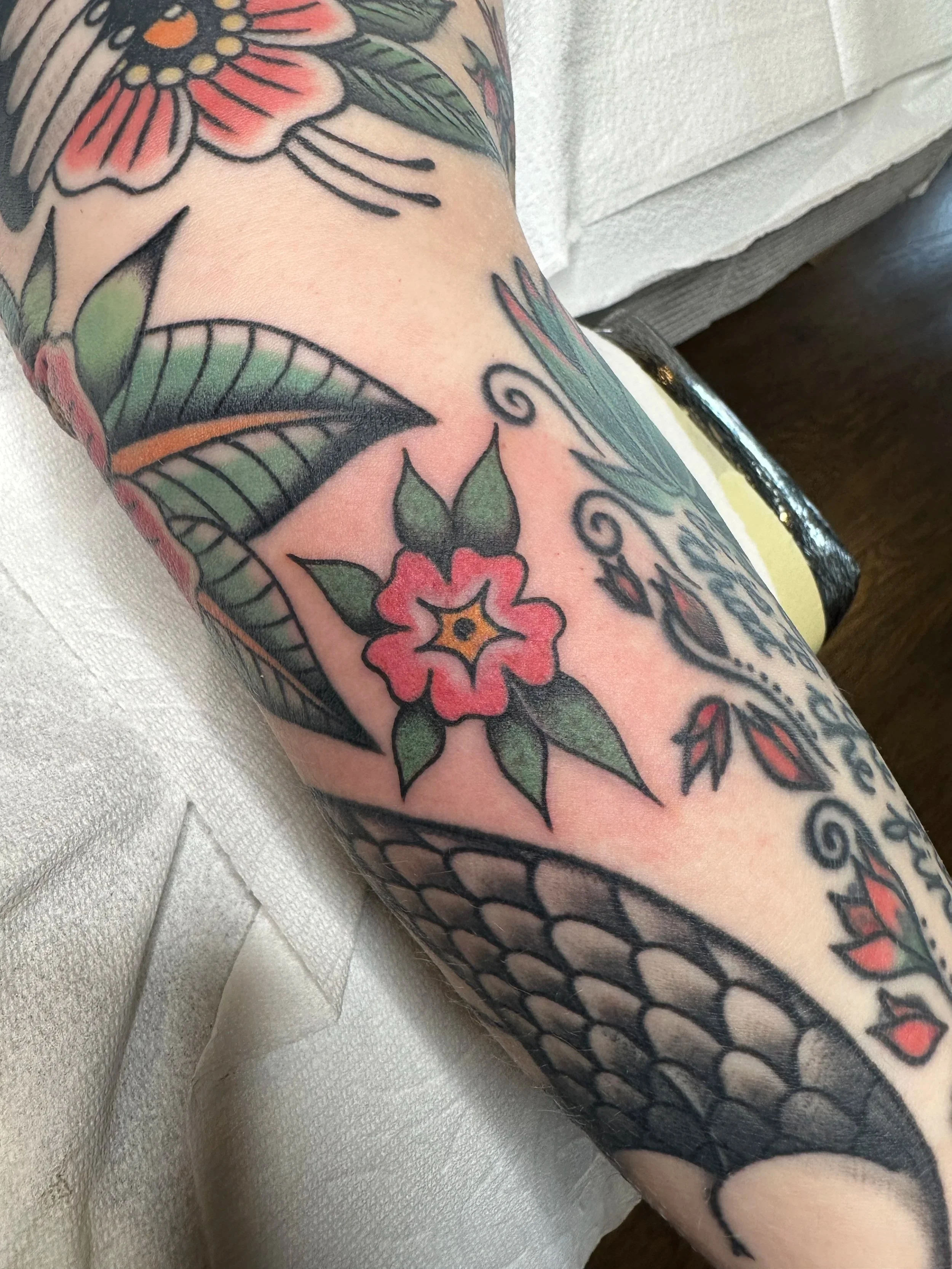 Here’s a little filler flower I made for my really good client. A lot of her tattoos are on this gallery because she is DEDICATED and comes in at least once a month. All the tattoos around it are by me, except The one peeking around the side of her a