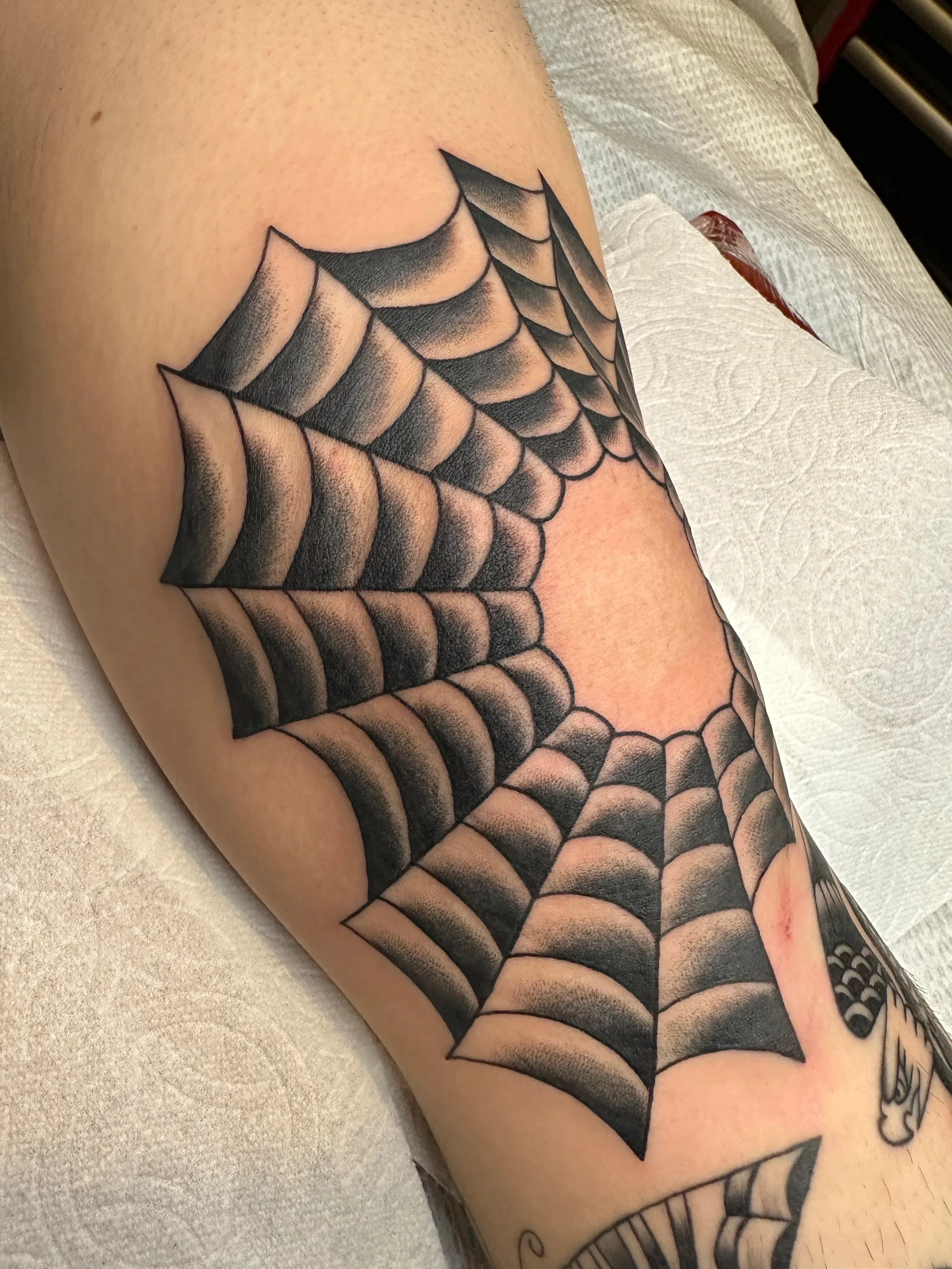 Classic spiderweb knee tattoo for my client who needed to fill his whole leg in no time flat. Twice a week appointments were the regular until we filled the whole thing up.