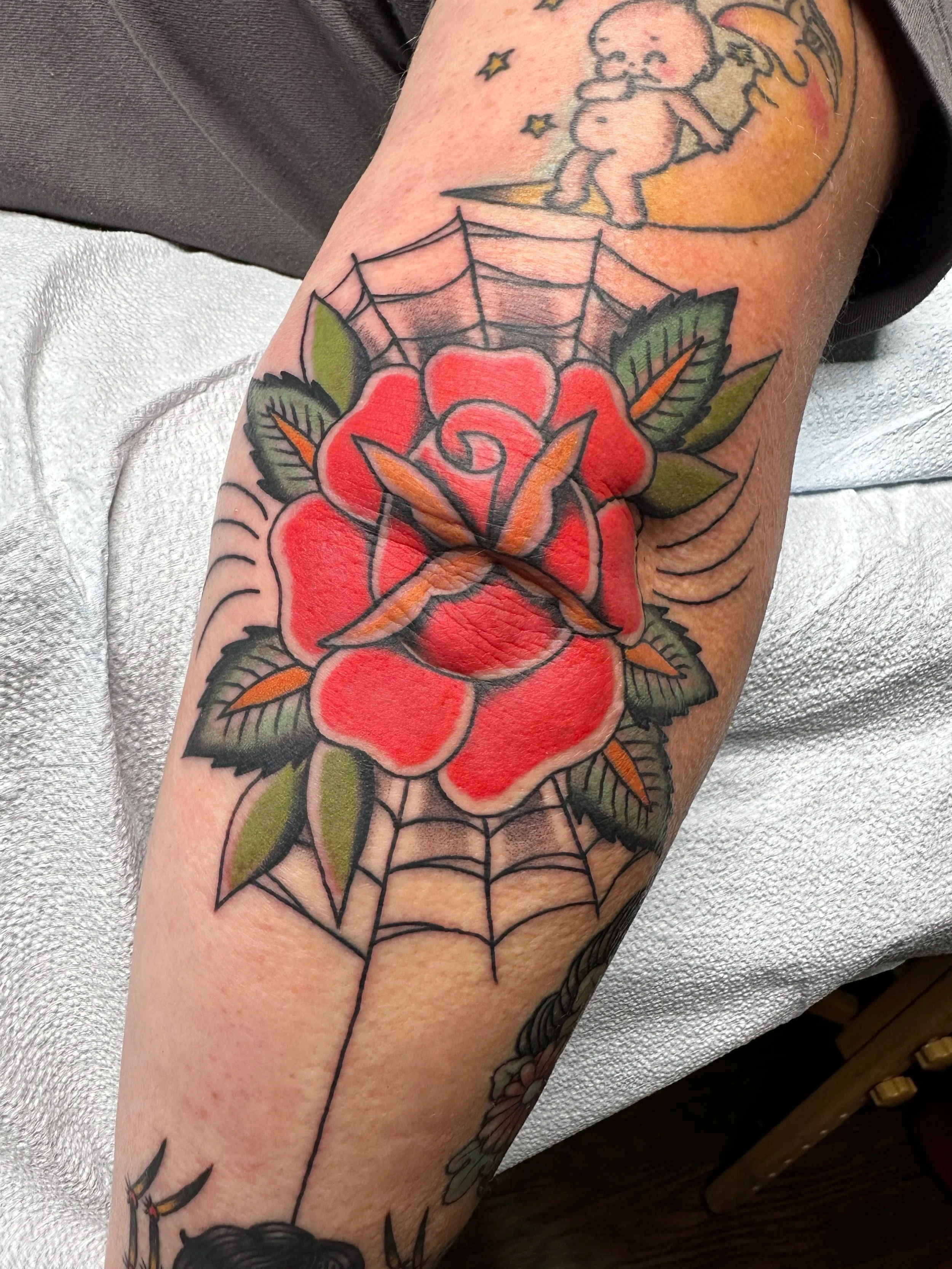 When this client gets a tattoo, her husband has to get one too. And they’re usually similar which I think is cute and endearing. He got a rose tattoo and a spider tattoo with the web so she combined them and got this red traditional rose with web and