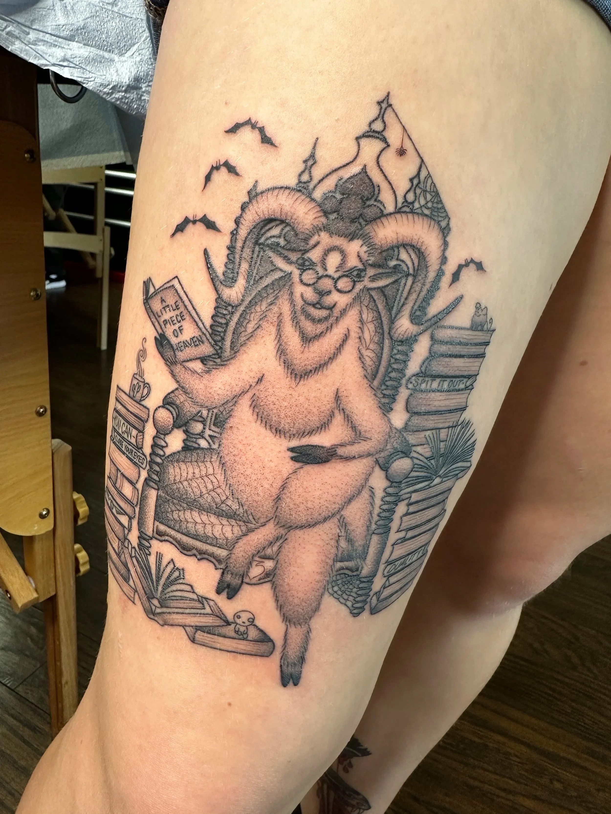 My client is a voracious reader and wanted this thigh piece of an old goat on a luxurious chair surrounded by books. I believe this is a portrait of her when she grows old.