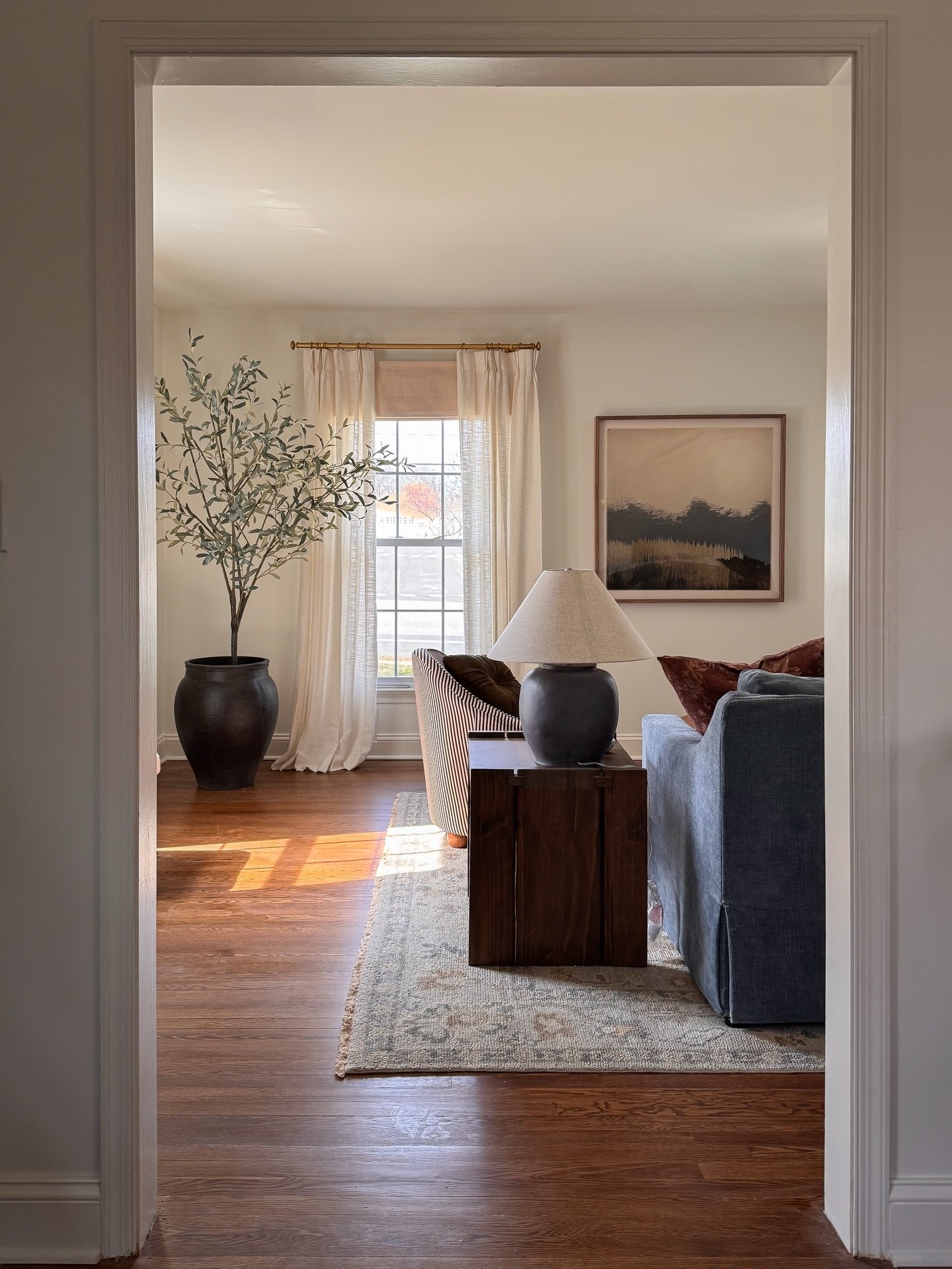 The living room from a recent project: both light + airy and full of color! ✨Swipe for more views!

This room feels so cozy and fun and unique! One of my favorite parts is how we turned family photos into a gallery that doubles as art with the tone o