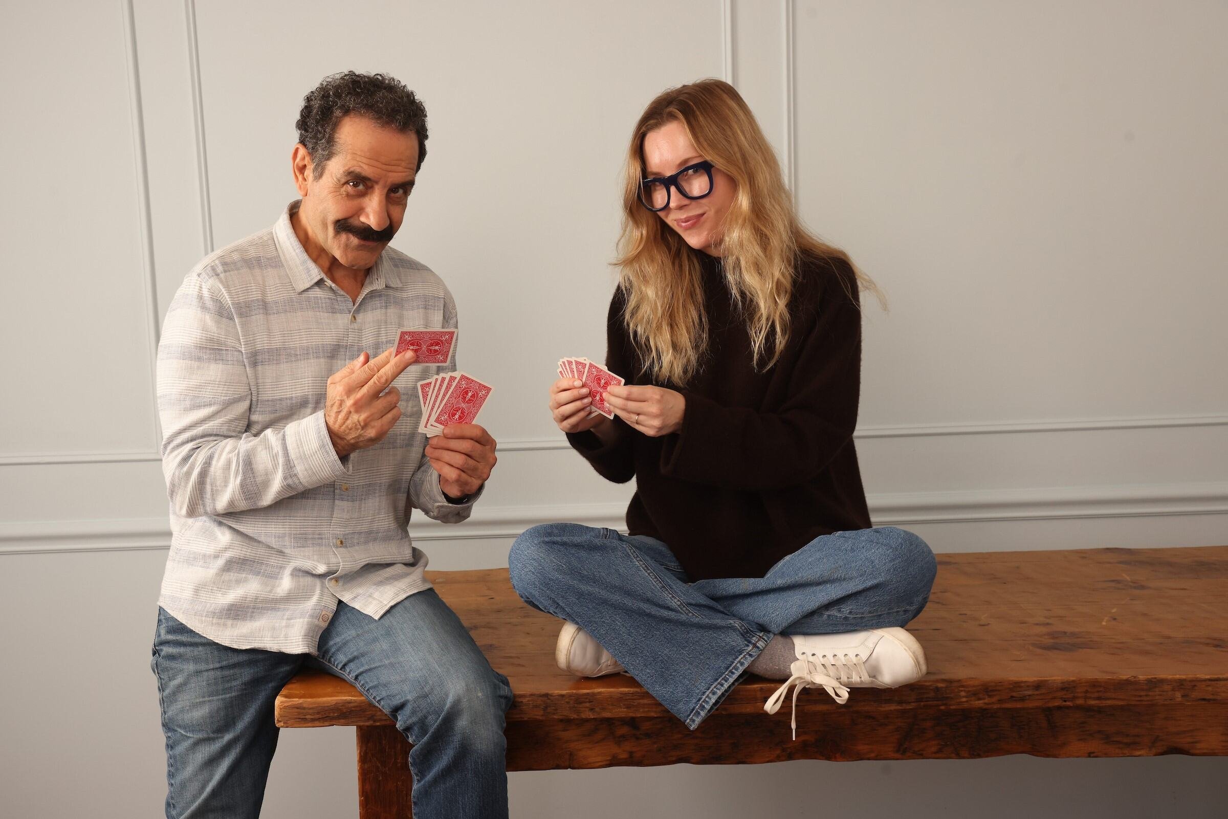 Father and daughter Josie Adams and Tony Shalhoub play cards.