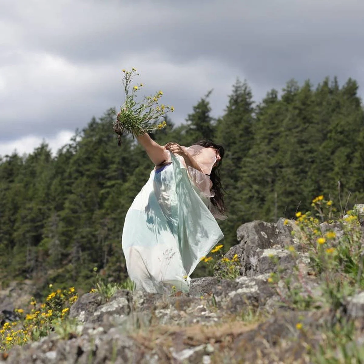 woman-with-flowers-on-rocks.jpg