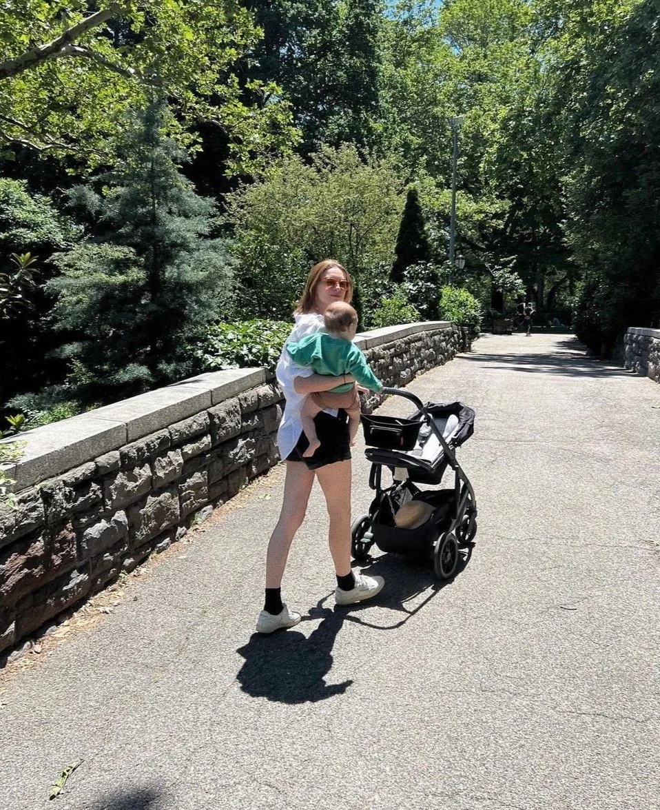 Sleep consultant for babies taking baby on a walk through the park