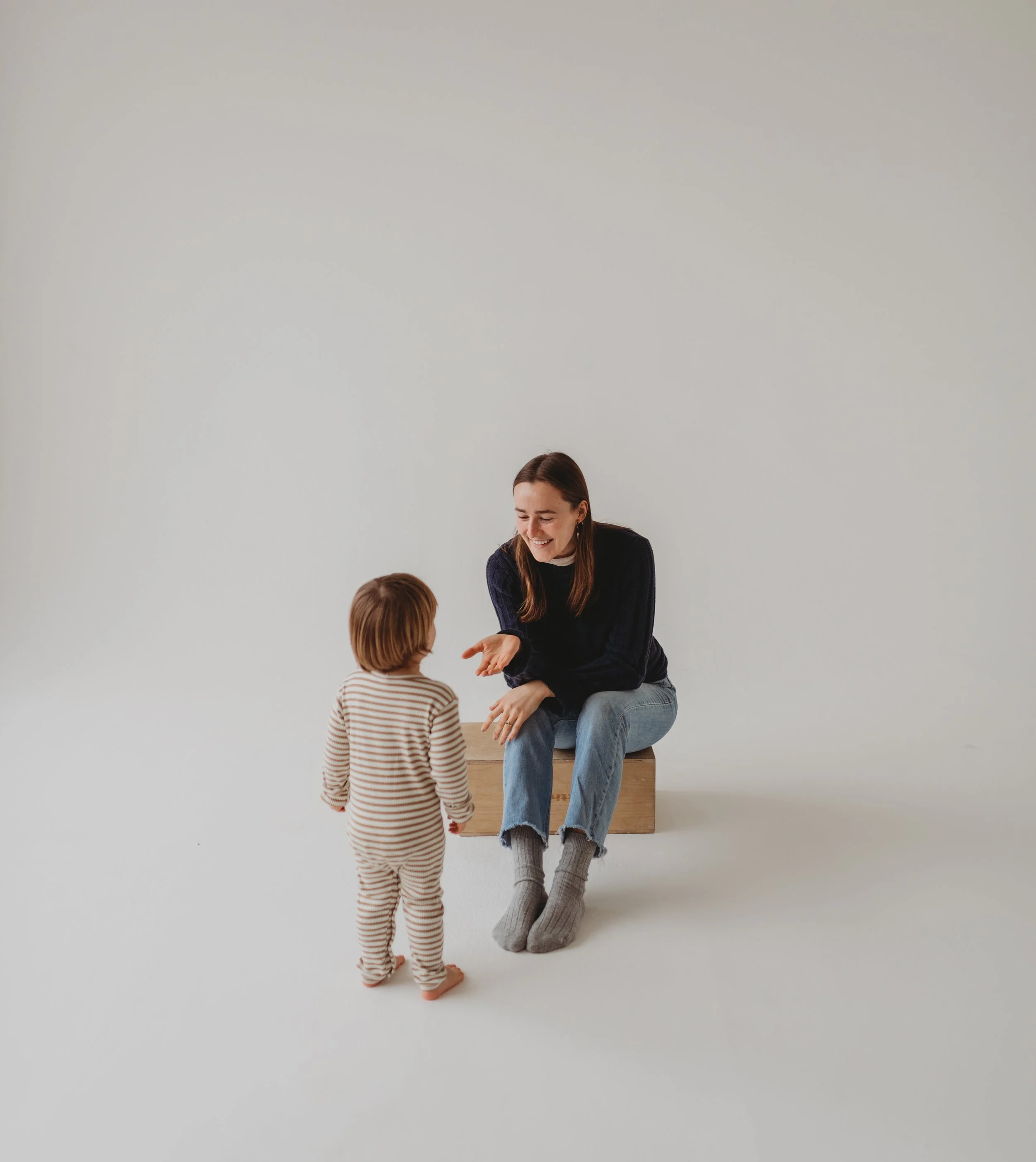 Toddler walking up to mother who is a sleep consultant