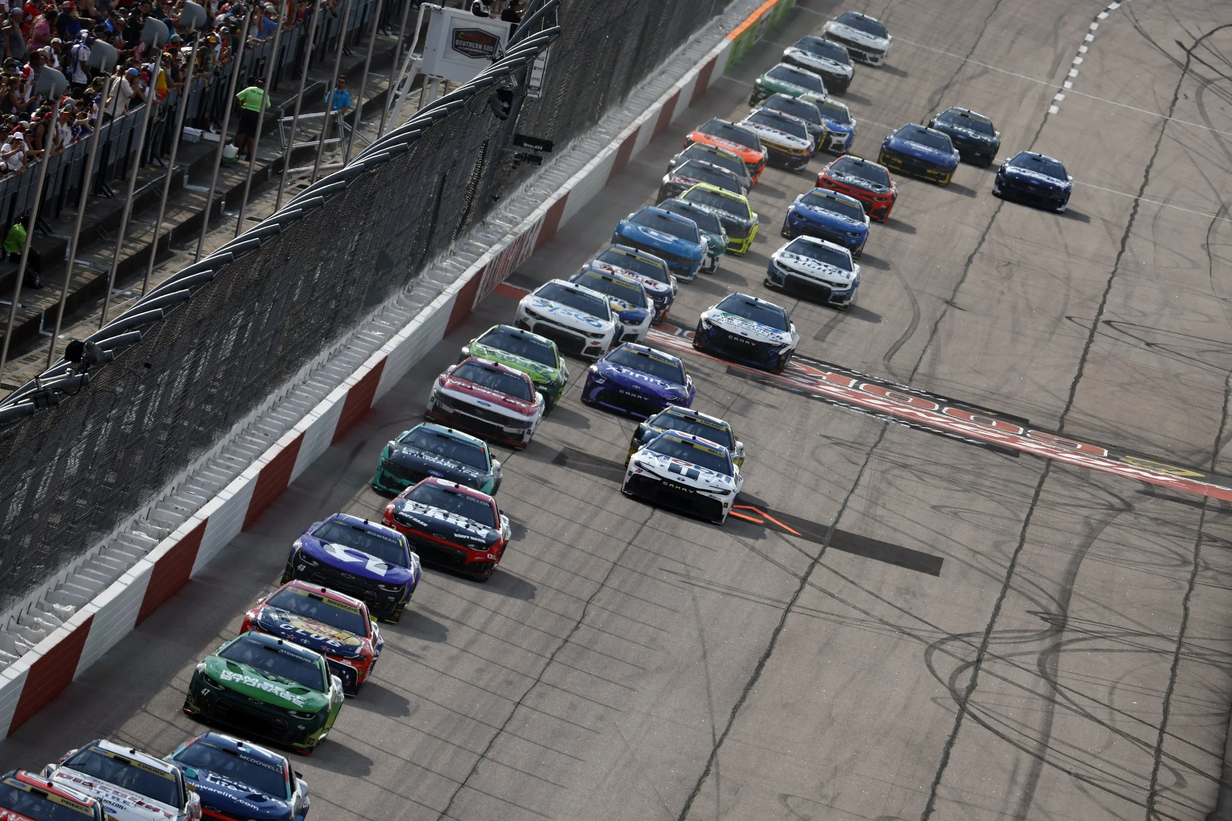 Stock Cars in a group racing at Darlington Raceway