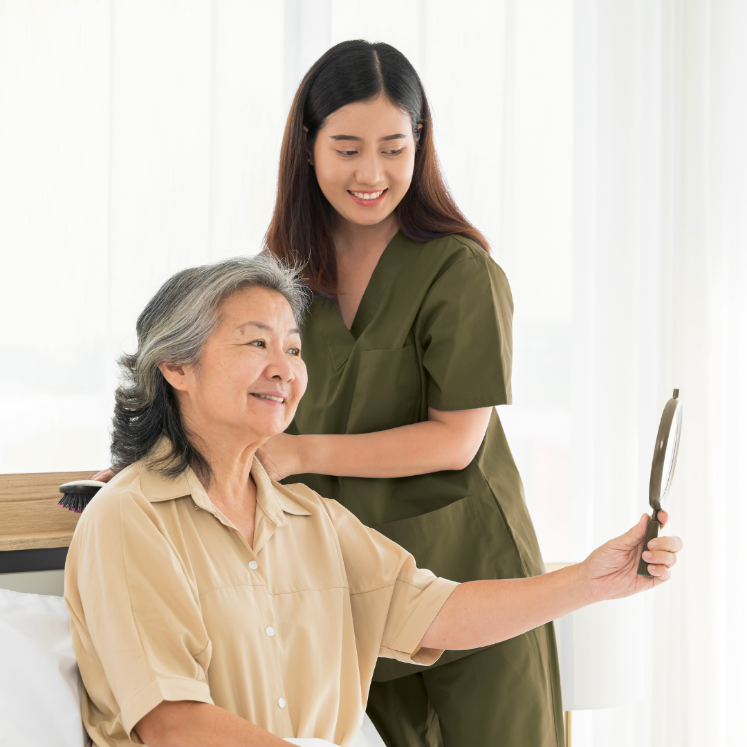 Caregiver assisting female client with daily grooming routine