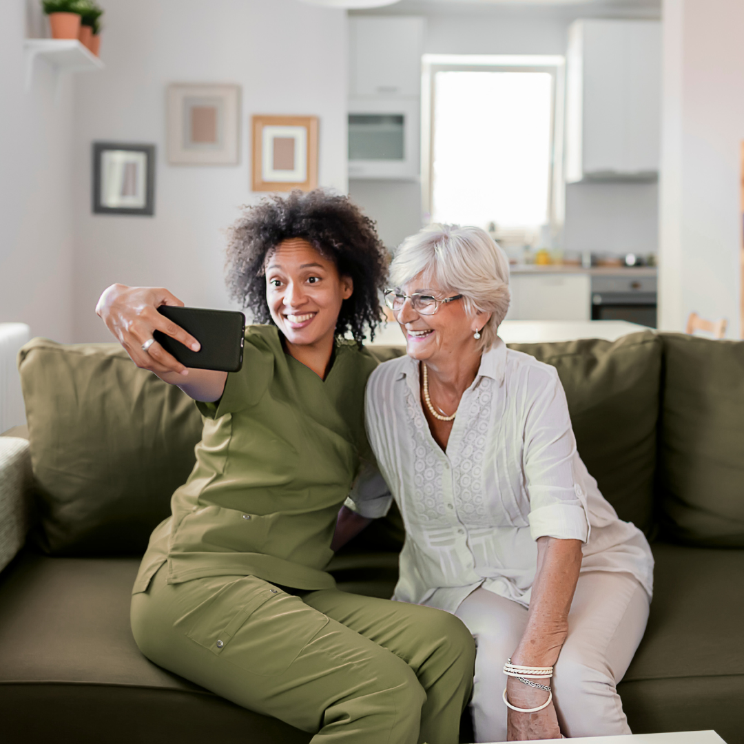 Caregiver spending fun time with client taking selfies