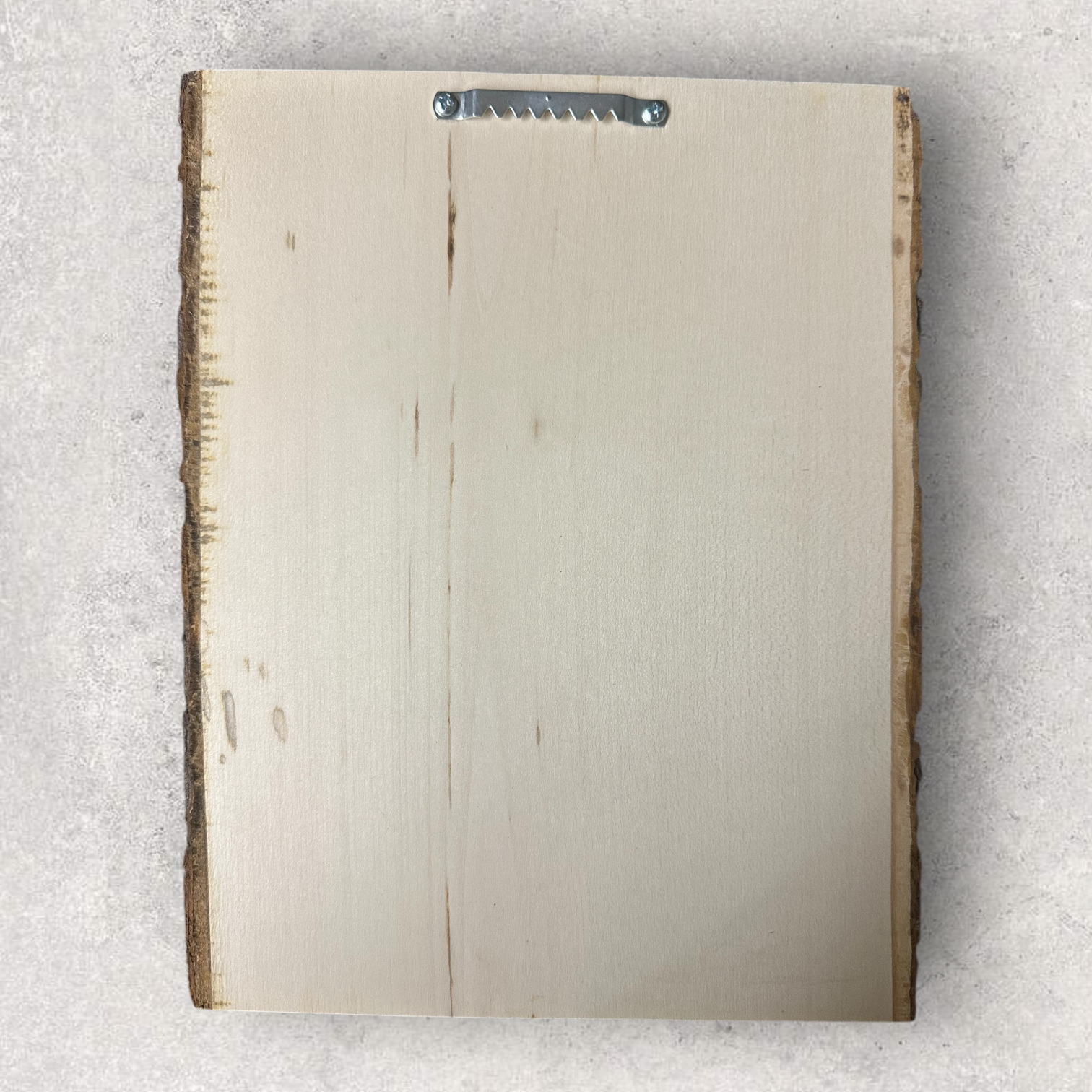 Rear view of live edge wood plaque with attached sawtooth hanger for wall mounting