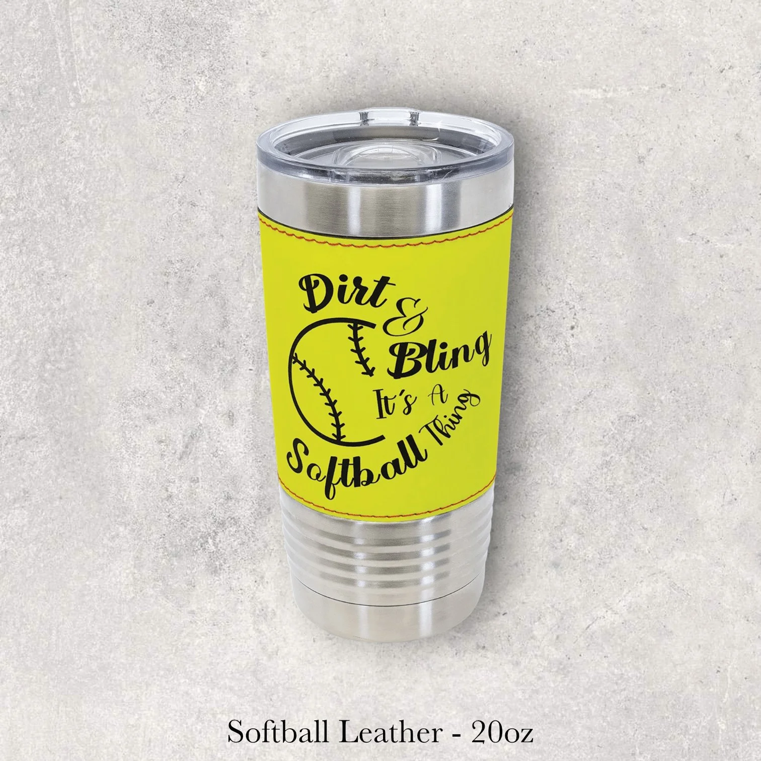 Silver base softball leather 20oz tumbler with “Dirt & Bling It’s a Softball Thing” text and softball graphic, engraved by Lazeric