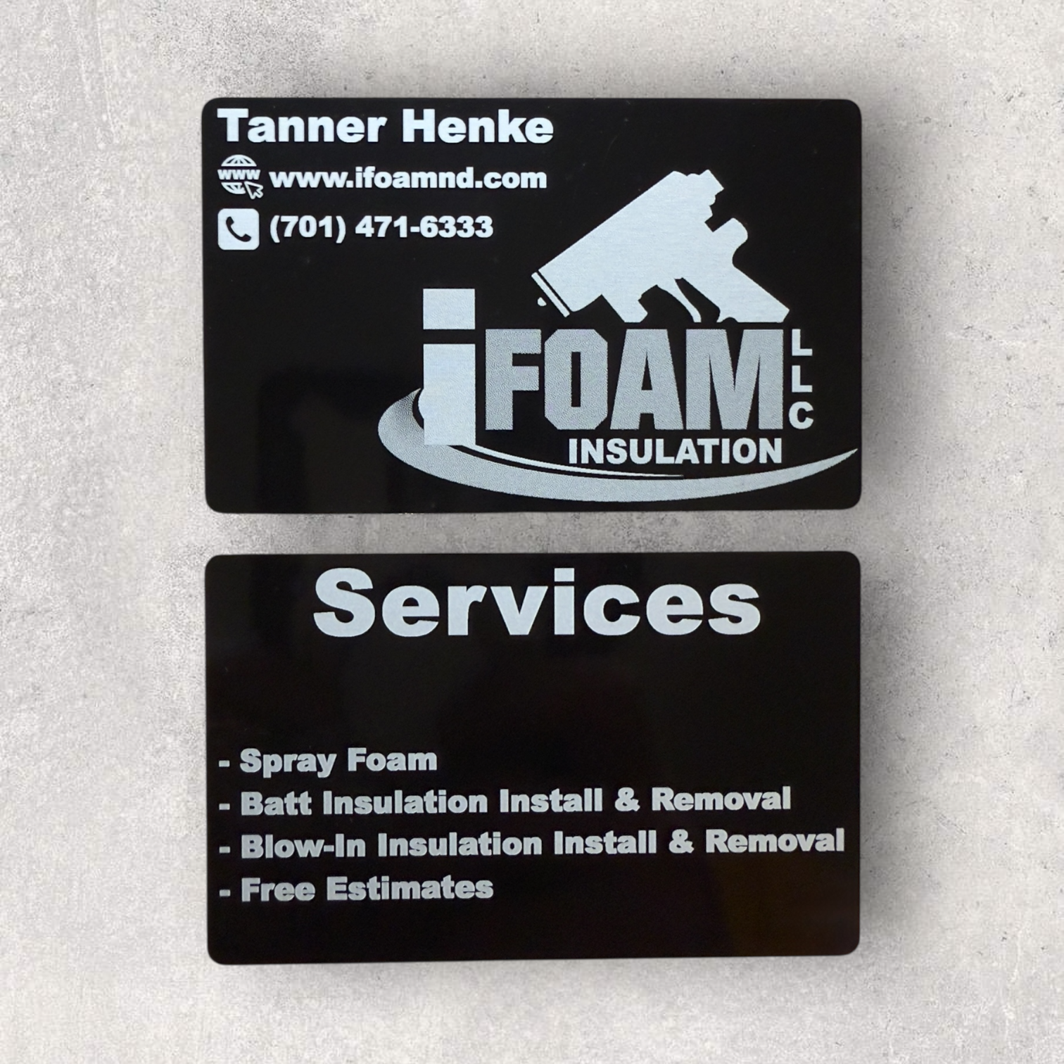 Custom laser engraved metal business cards for iFoam LLC, showcasing company logo, contact details, and listed services - Lazeric