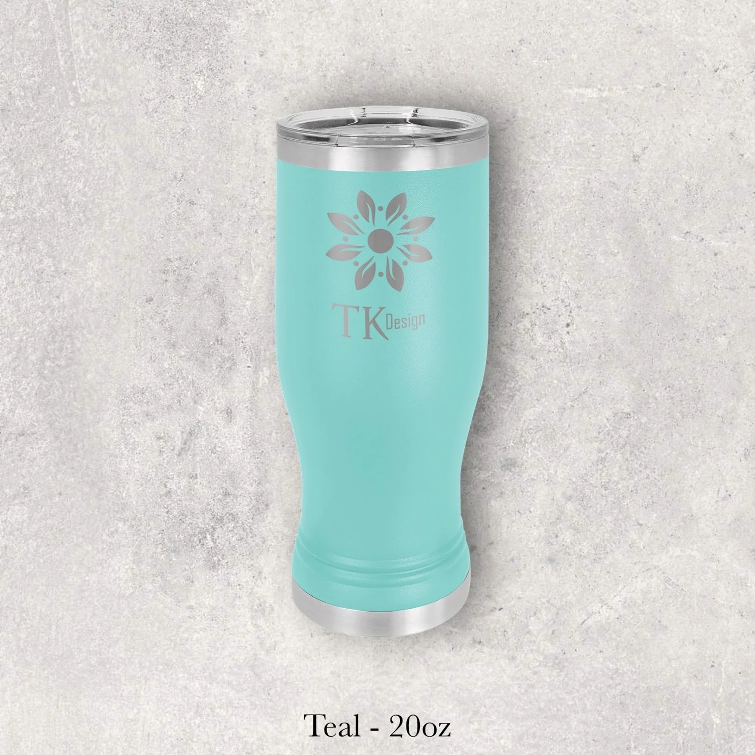 Teal 20oz pilsner-style tumbler engraved by Lazeric with a floral TK Design logo.