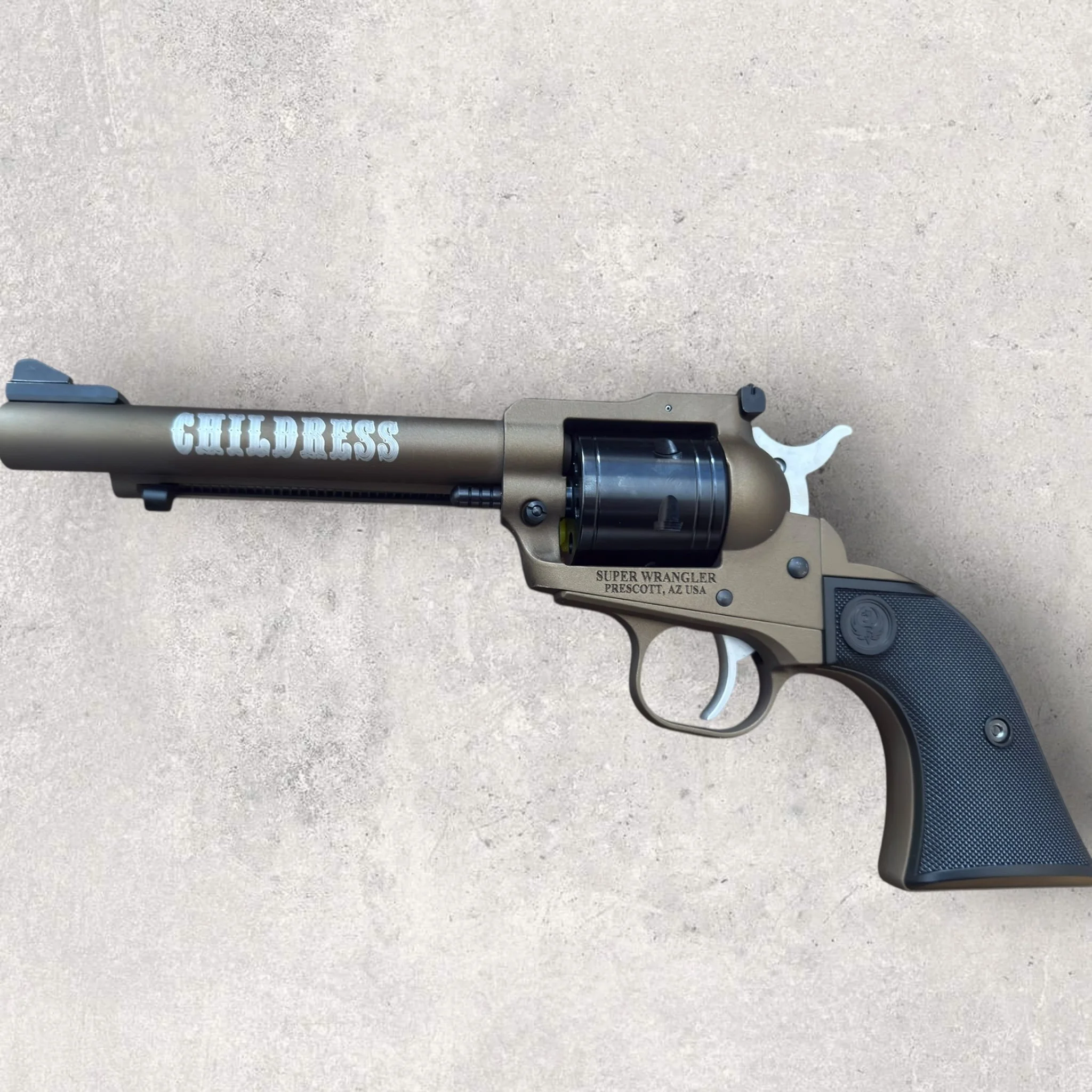 Laser-engraved revolver with custom name engraving on the barrel, showing personalized firearm engraving on a customer-owned handgun by Lazeric
