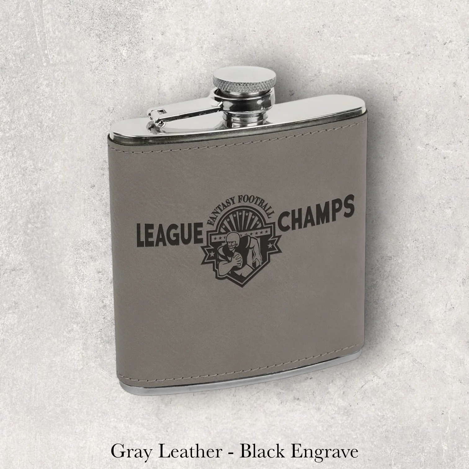 Gray leather 6oz flask with League Champs crest logo, black laser engraving, engraved by Lazeric