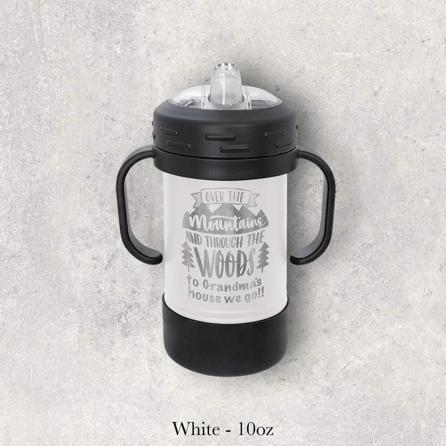 White – 10oz metal sippy cup engraved with mountain and forest quote design reading “Over the mountains and through the woods…,” custom laser engraved by Lazeric.