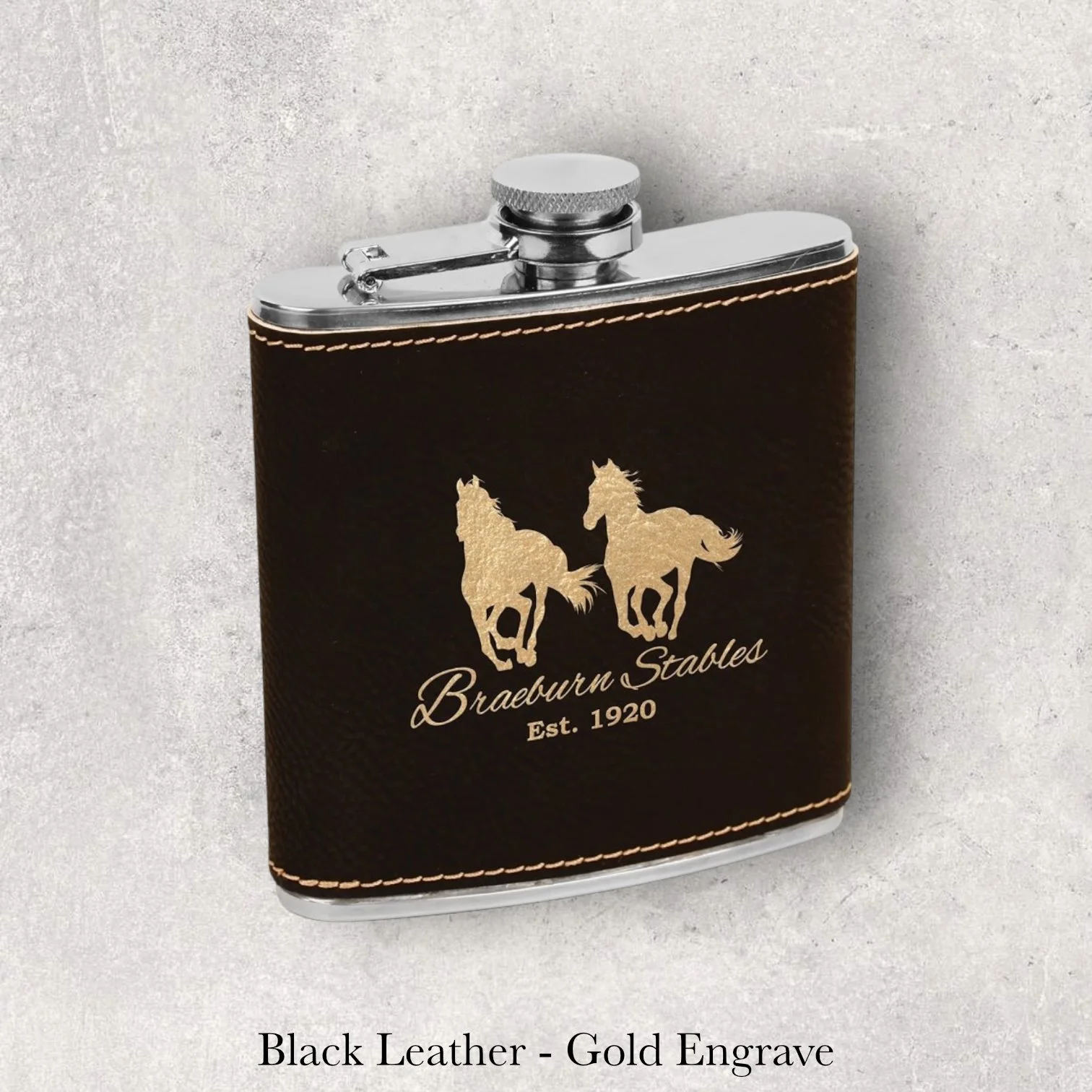 Black leather 6oz flask with Brewster Stables Est. 1920 logo, gold laser engraving, engraved by Lazeric