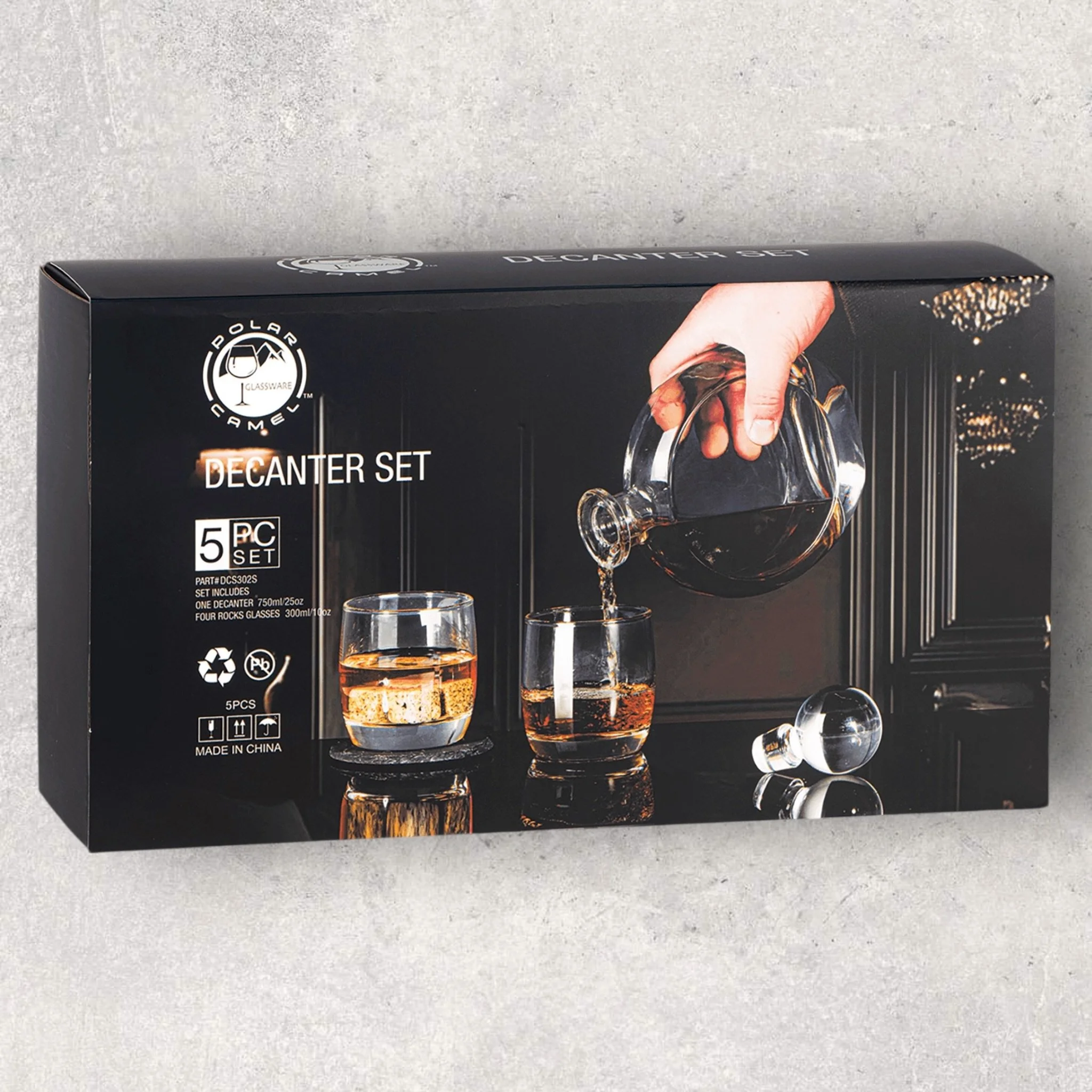 Retail packaging for round glass decanter set with four rocks glasses, engraved by Lazeric