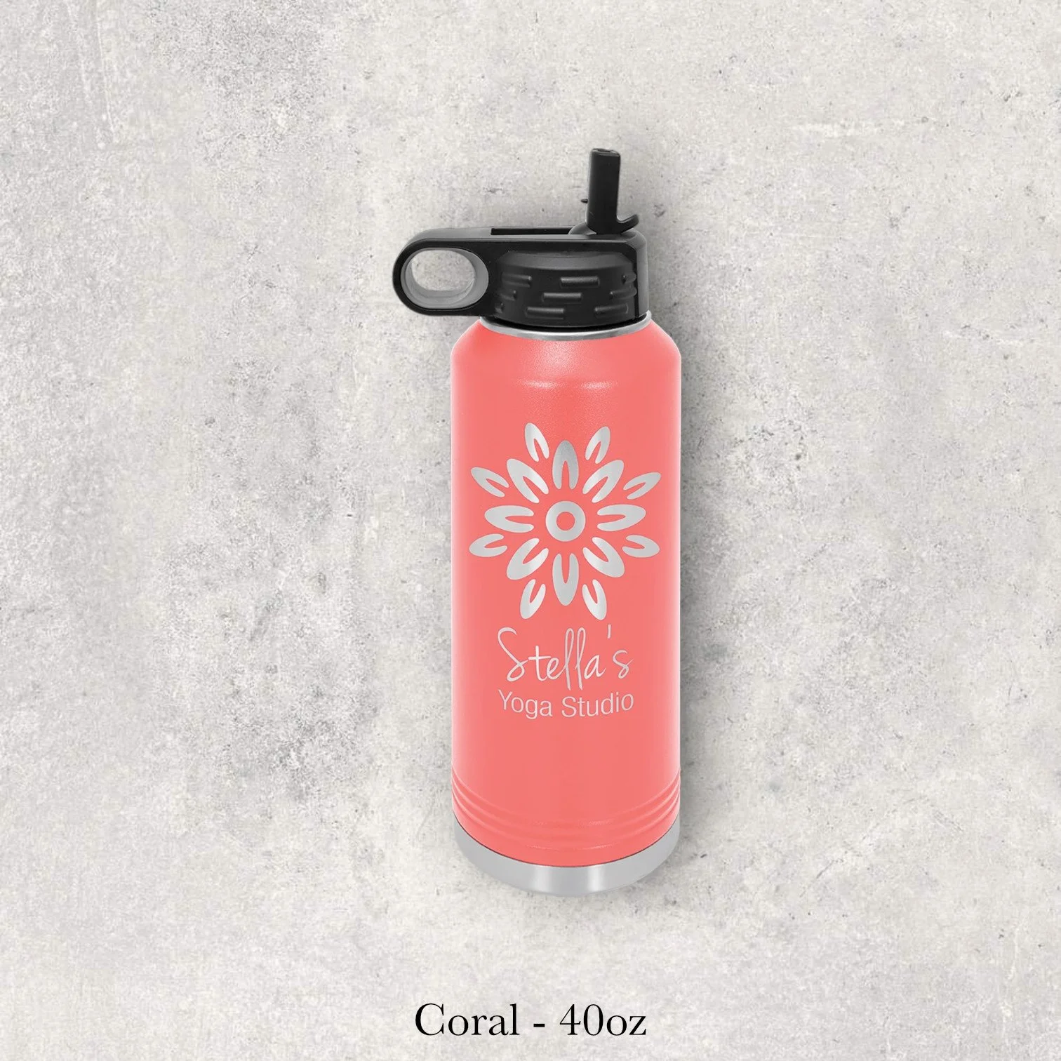 Coral 40oz metal water bottle engraved by Lazeric featuring a yoga studio logo with a floral mandala design.