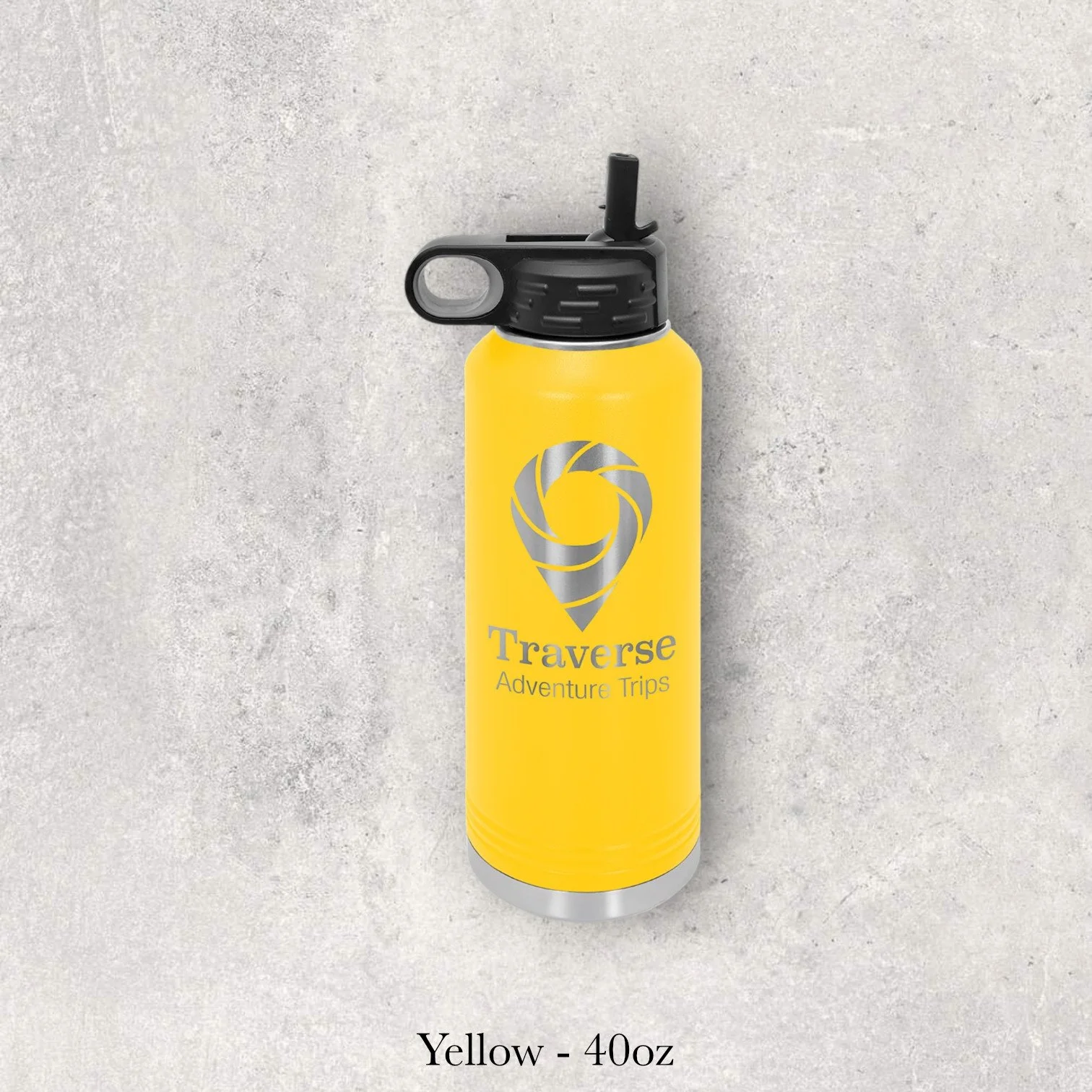 Yellow 40oz metal water bottle engraved by Lazeric featuring a travel logo with a spiral compass-style icon and text.