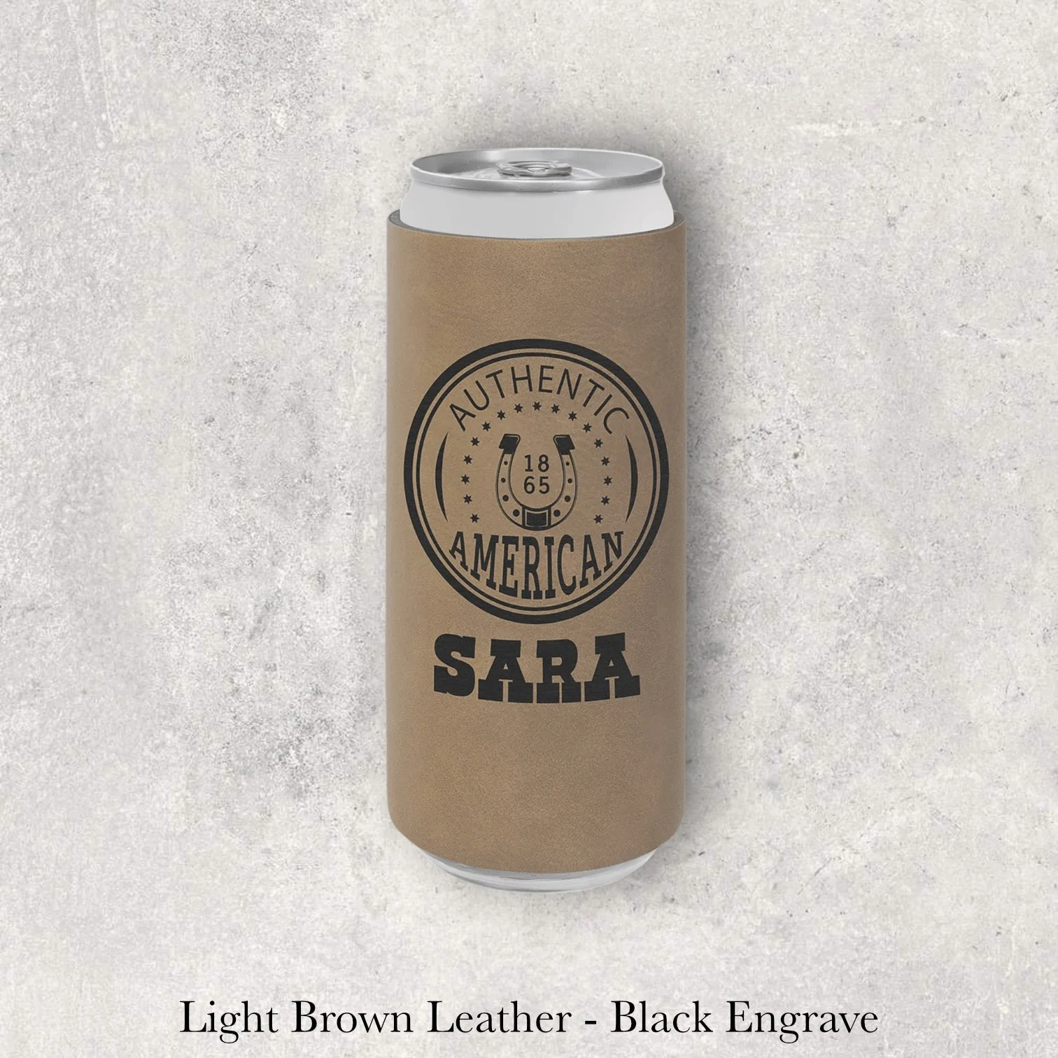 Light brown leather slim can coozie with black laser-engraved Authentic American circular logo and name, engraved by Lazeric