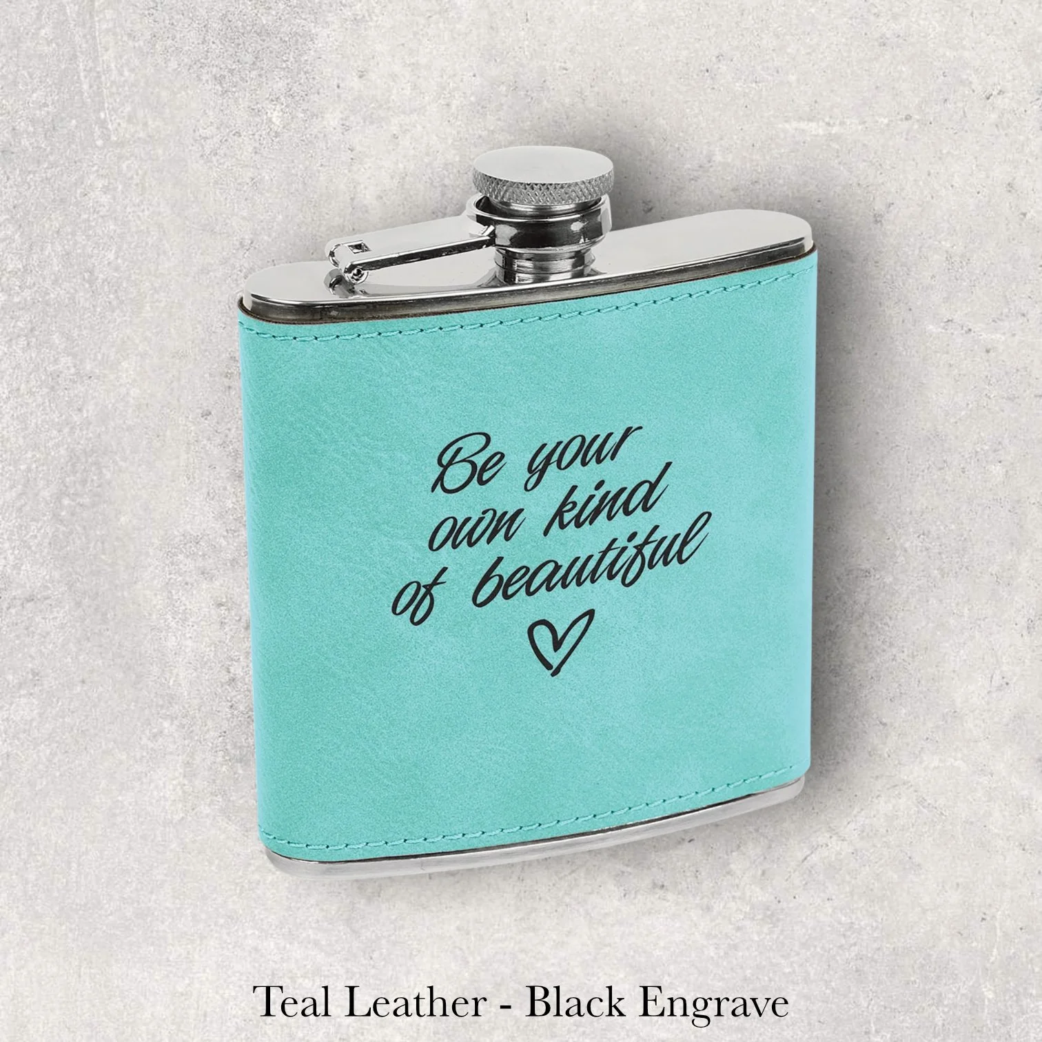 Teal leather 6oz flask with “Be your own kind of beautiful” text, black laser engraving, engraved by Lazeric