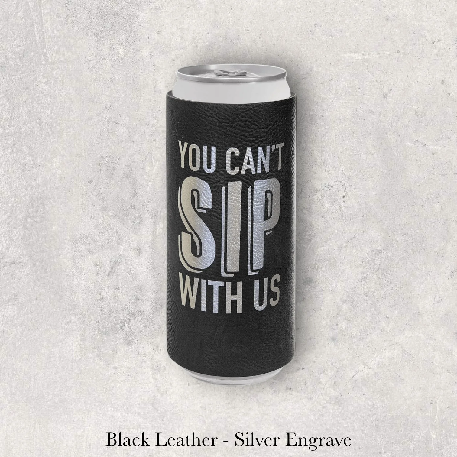 Black leather slim can coozie with silver laser-engraved “You Can’t Sip With Us” text design, engraved by Lazeric
