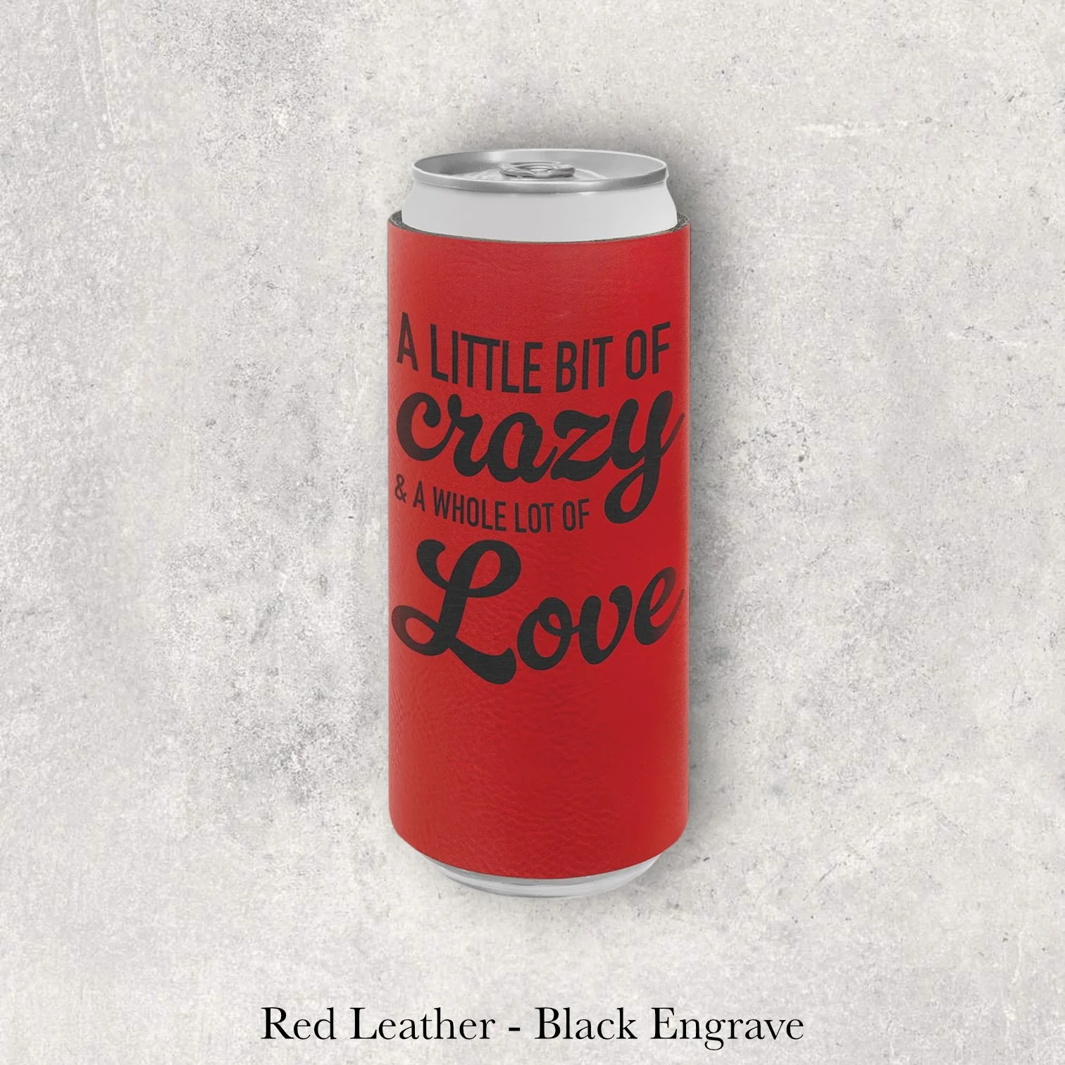 Red leather slim can coozie with black laser-engraved “A Little Bit of Crazy & a Whole Lot of Love” text design, engraved by Lazeric