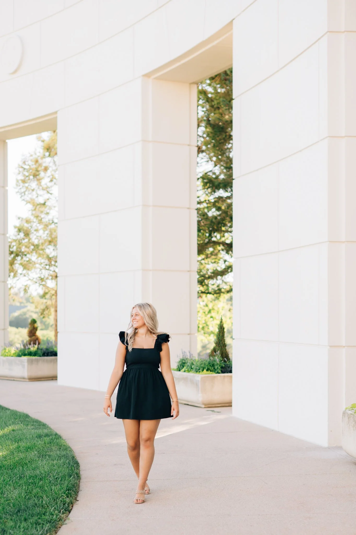 Girl poses in Memorial Park for her summer senior pictures in Omaha.
