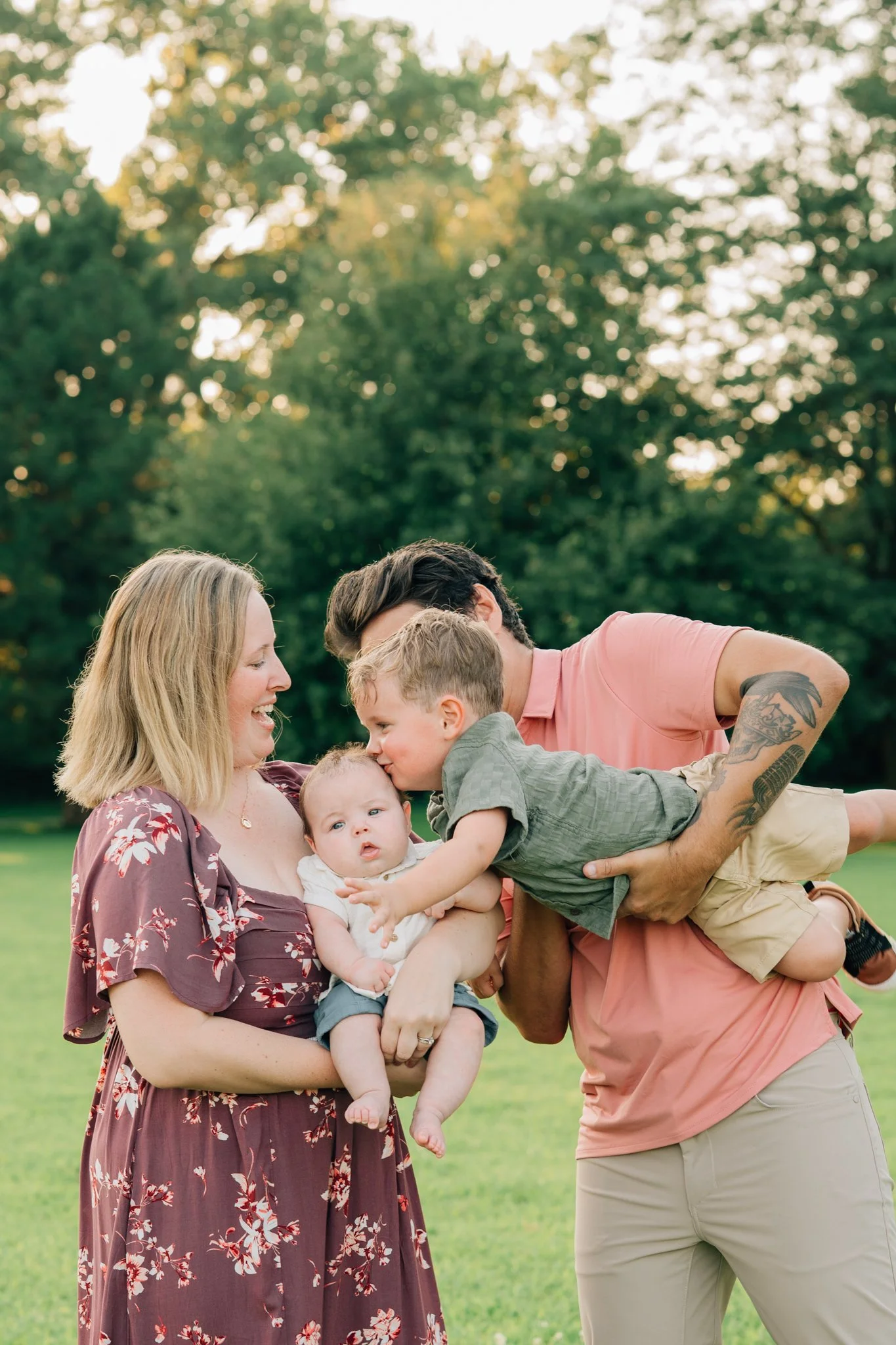 parents holding young children laughing during family photos.