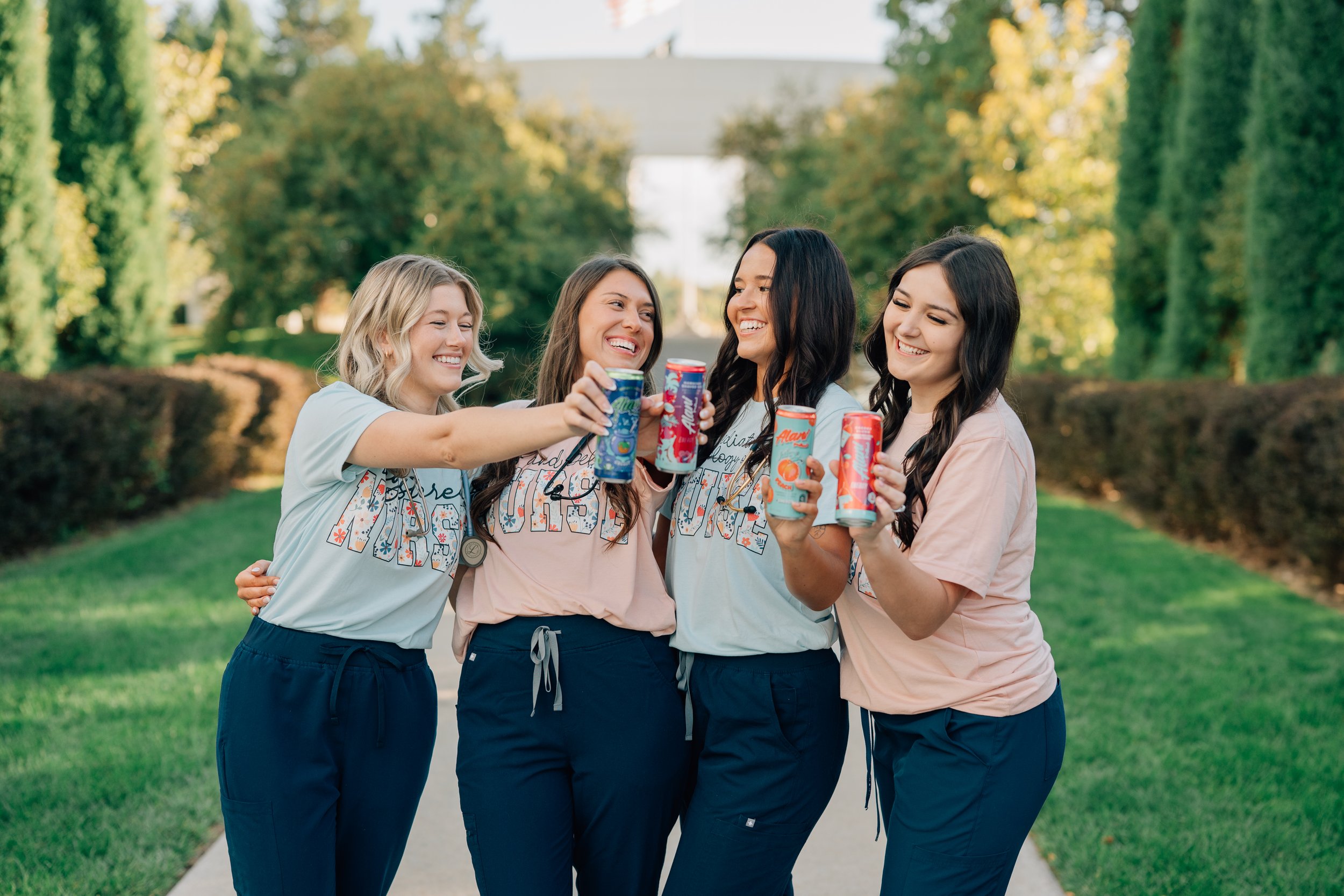 Four friends cheers alanis during their college graduation photo shoot as a nod to their friendship and the caffeine it took to graduate.