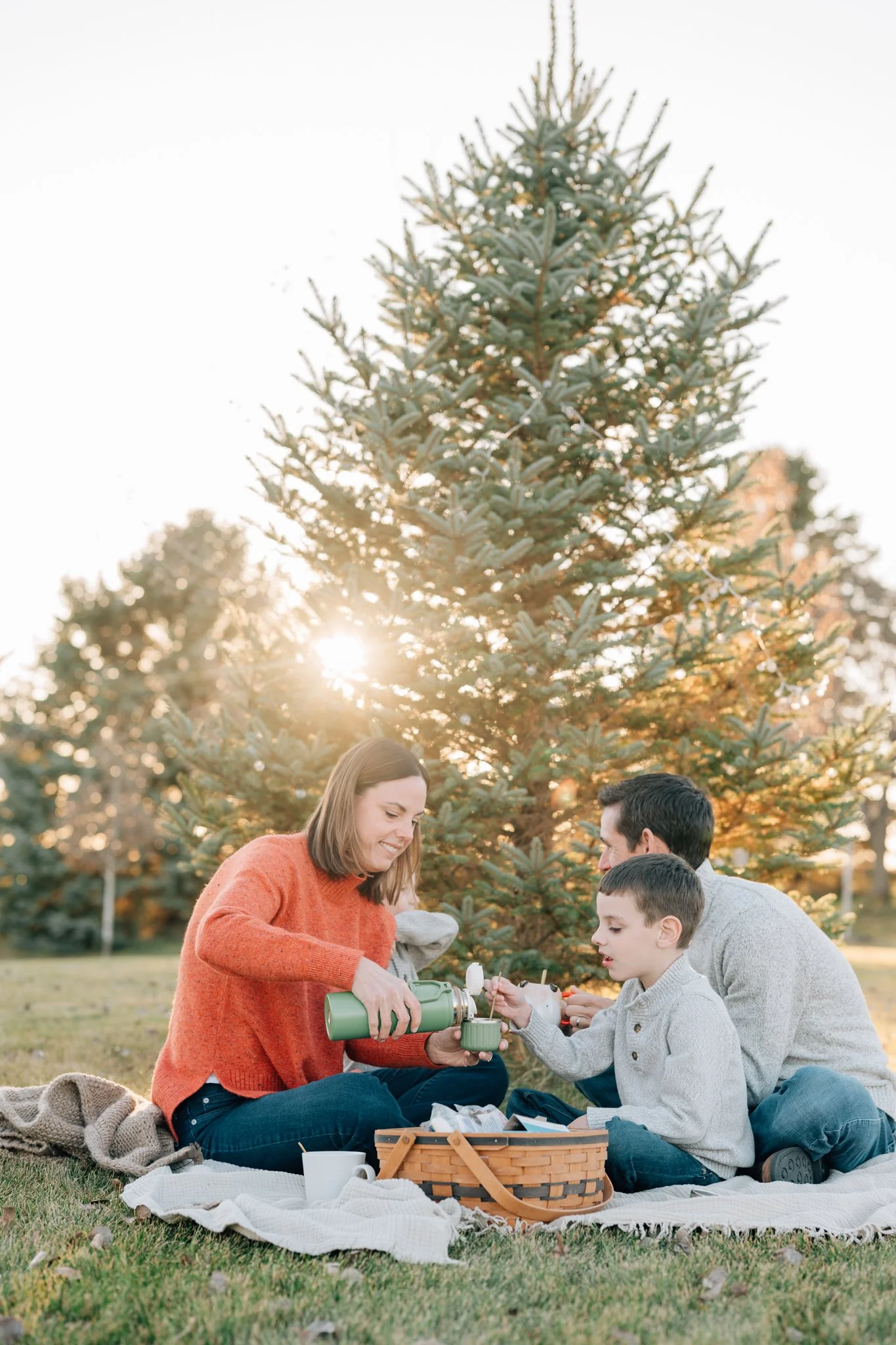 Family enjoys hot chocolate on a cold day in Iowa family photography session. 