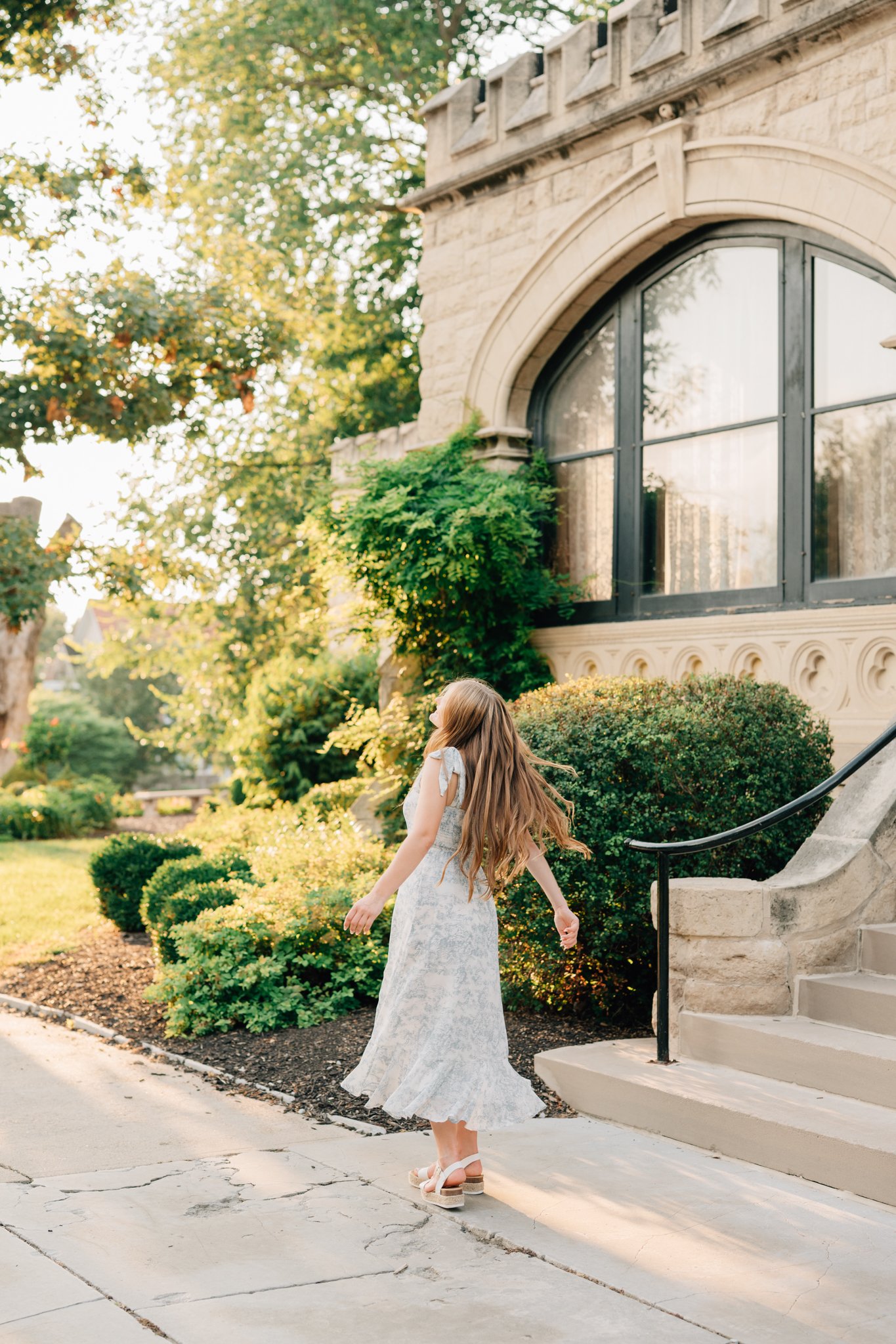 Girl twirls in front of Jocelyn castle for her senior pictures in Omaha.