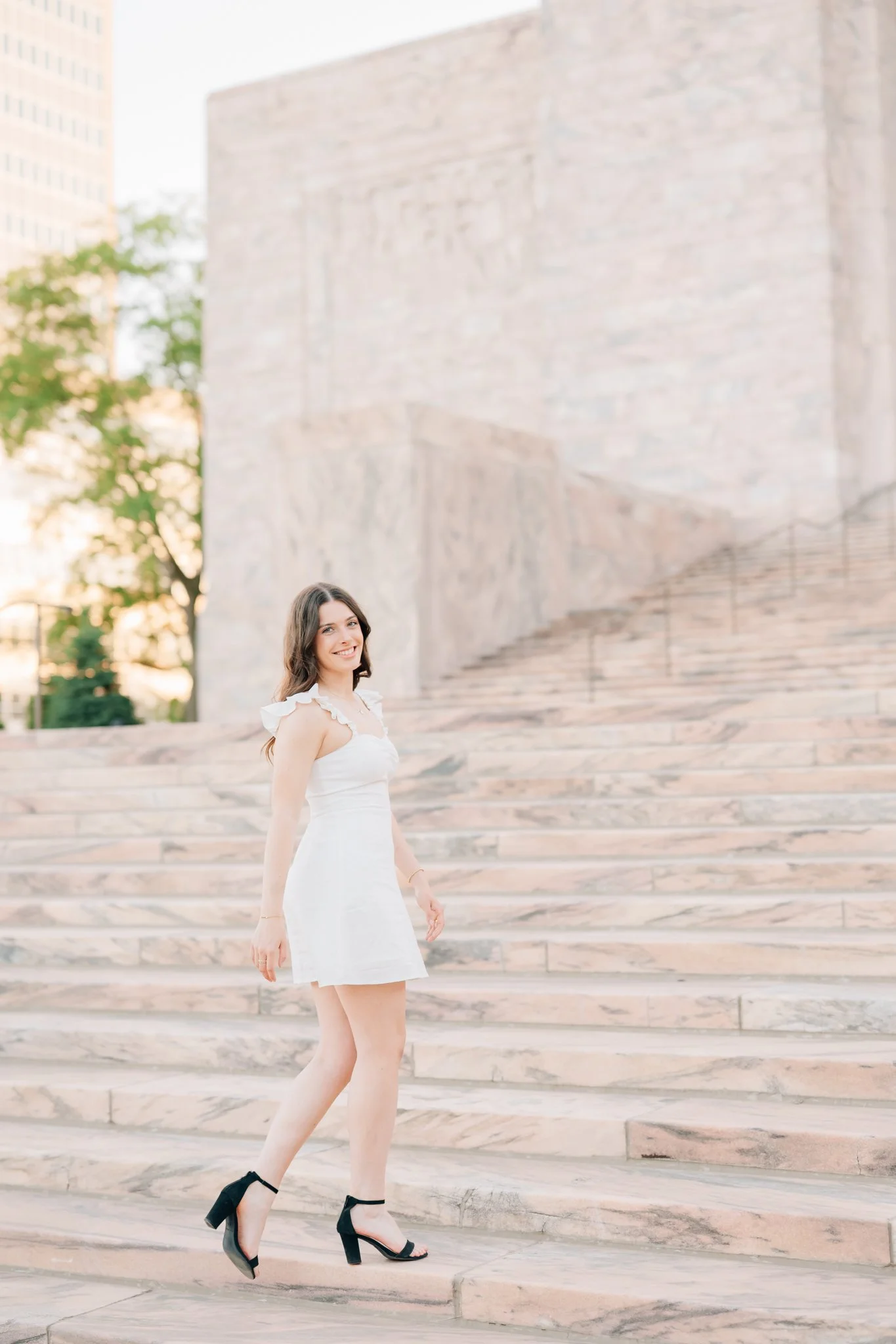 Girl walks up steps of Jocelyn Museum during photo session in Omaha.