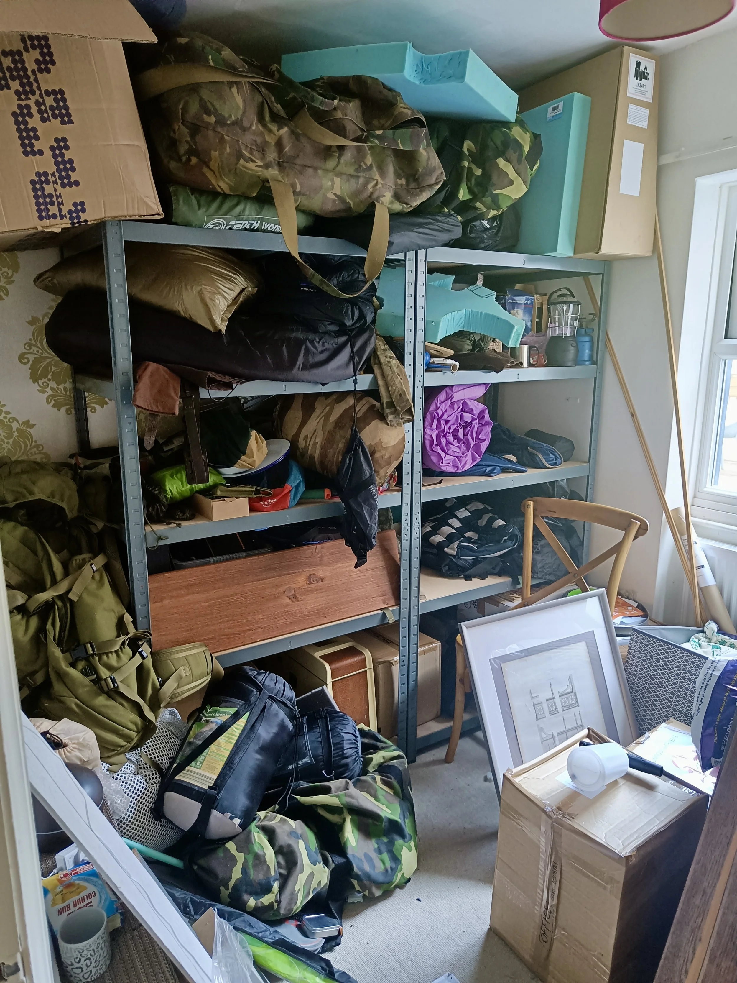professional decluttering and organising York - cluttered storage shelf full of chaotic sports gear