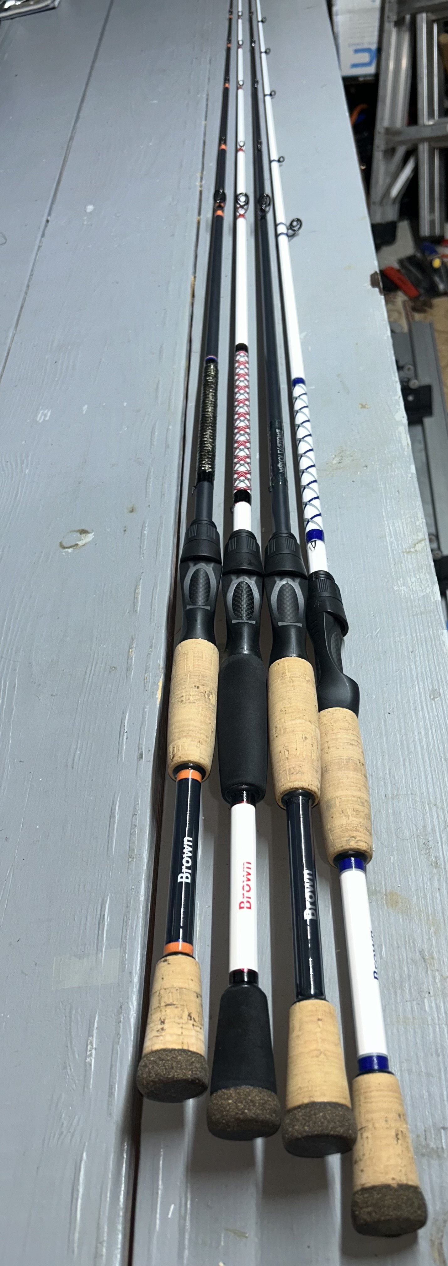 four fishing rods with cork handles and various designs