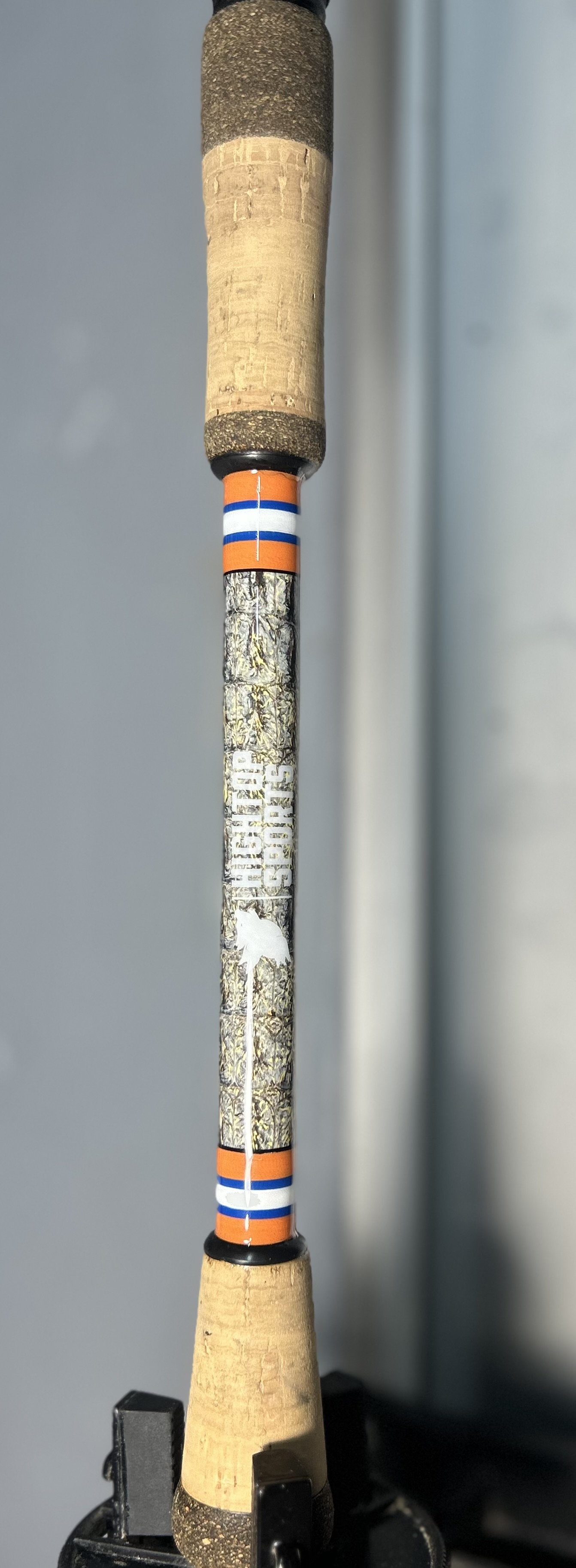 fishing rod handle with cork grips and decorative wrap