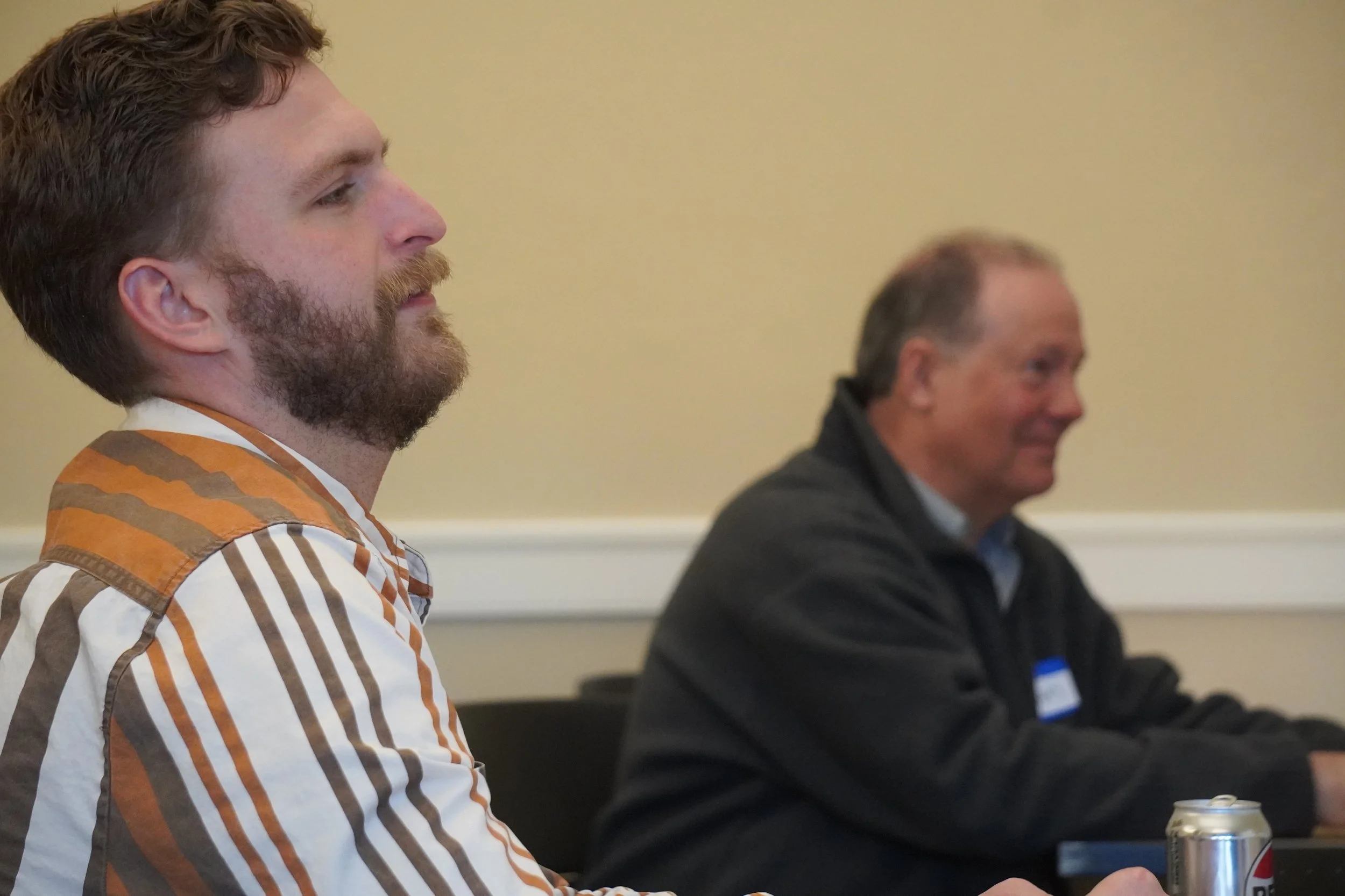 Carter Gudell, facilitator of the 2026 EO Innovation Jam, and Bryan Tweit from Launch Pad Baker listen to pitches from the 2026 EO Innovation Jam