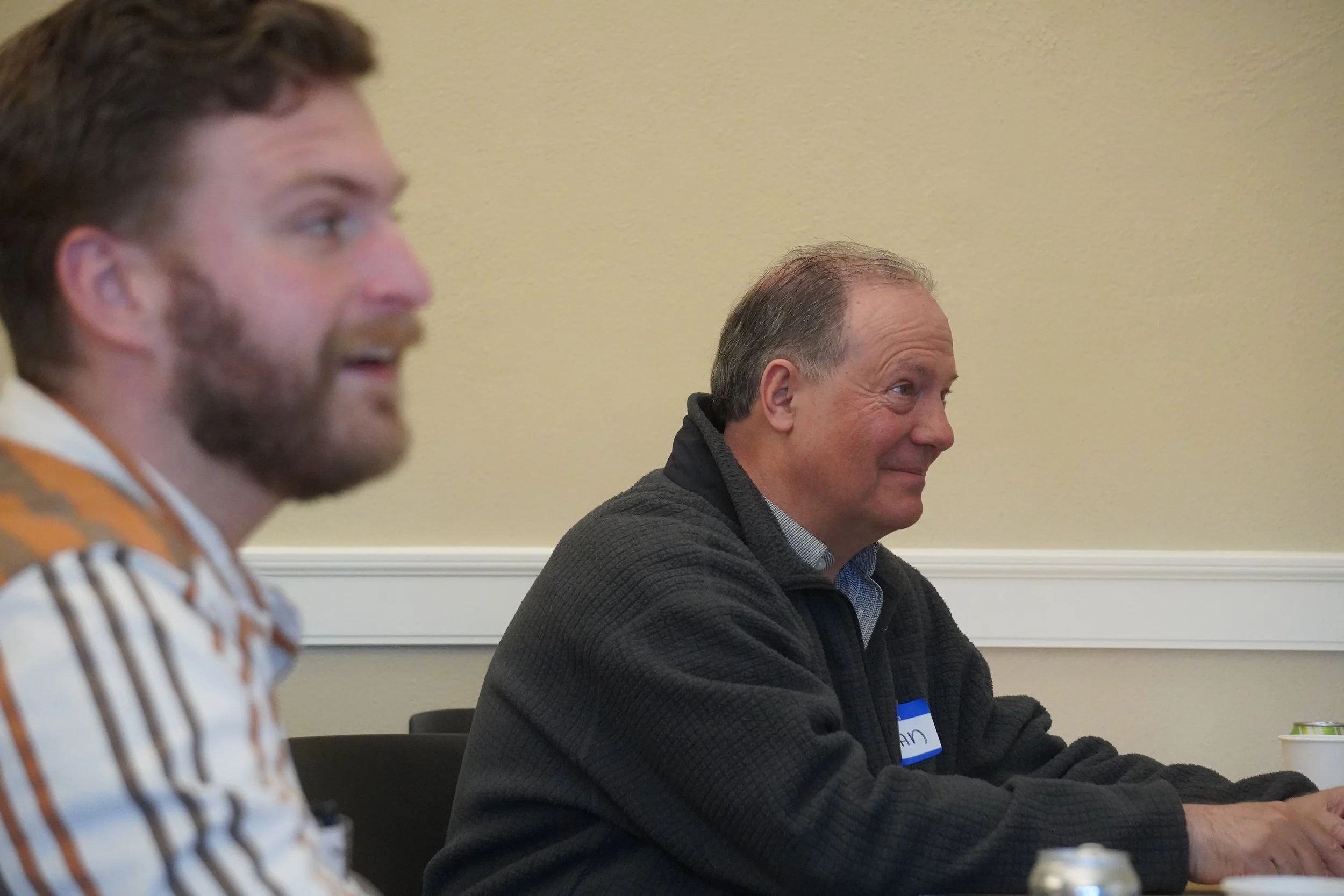 Carter Gudell, facilitator of the 2026 EO Innovation Jam, and Bryan Tweit from Launch Pad Baker listen to pitches from the 2026 EO Innovation Jam