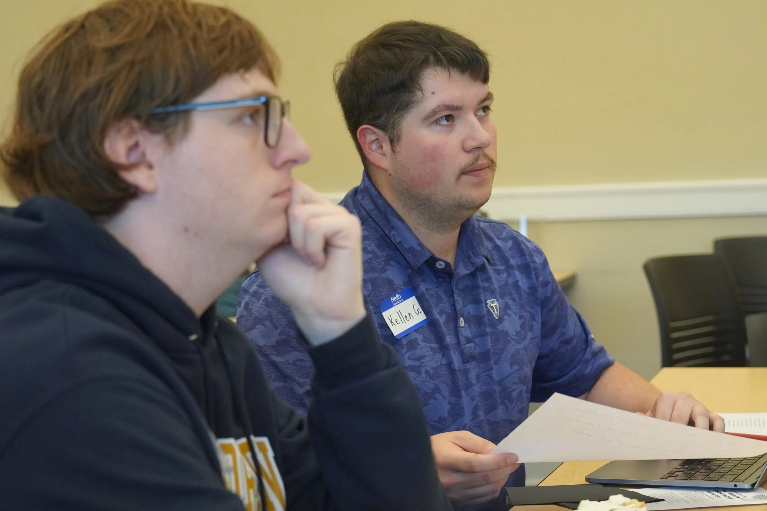 Left to right: EOU computer science student Adam Smith and EOU alum Kellen Grant listen to a mentor at the 2026 Innovation Jam