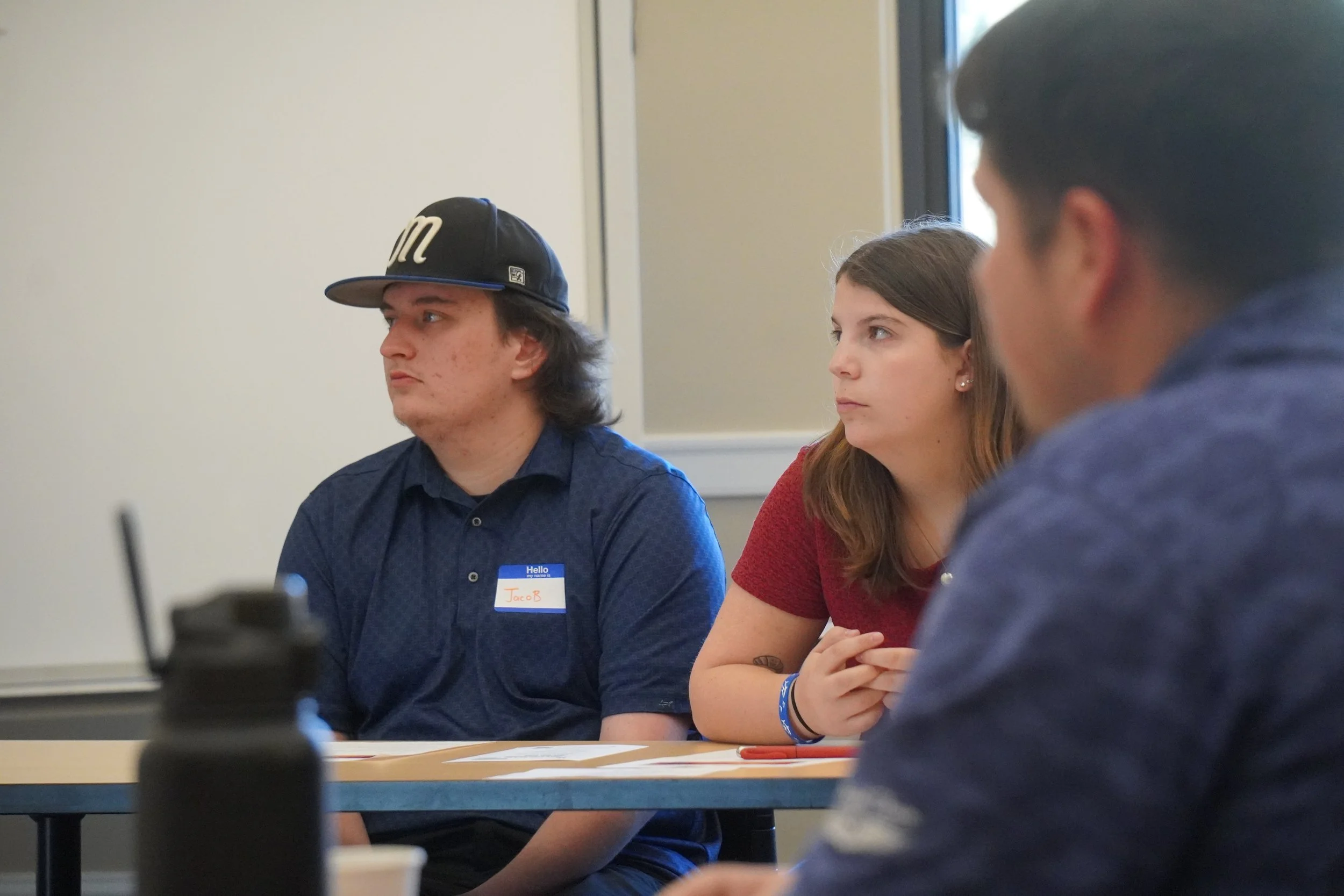 Left to right: EOU students Jacob Sanchez, Indy Gauthier, and EOU alum Kellen Grant listen to a mentor give advice on pitching their ideas