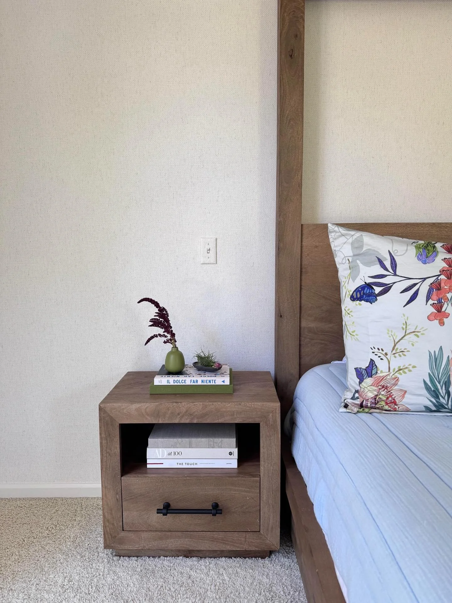 Adding textured wallpaper to this natural light-filled Primary Bedroom created the coastal feel that the client was seeking for this space. Even the light switch got an upgrade!