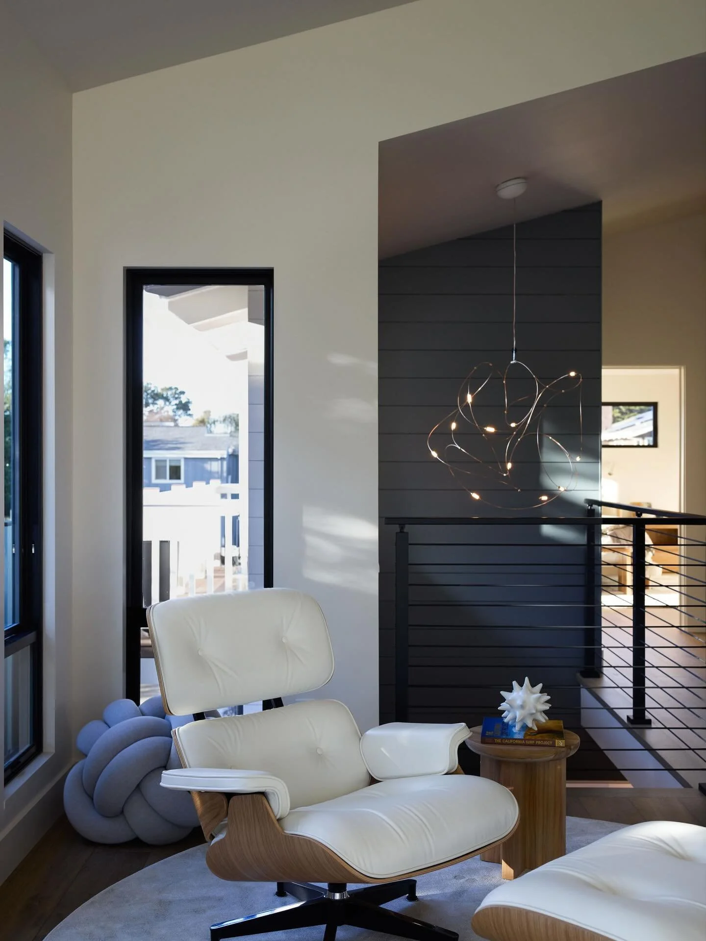 Reading space necessities:

- The most iconic &amp; ergonomic lounge chair/ottoman
- Natural light accompanied by fun interior lighting
- Functional side table
- Peace and quiet 

Furnishings &amp; Styling @compositioninteriorsinc
Architecture @found