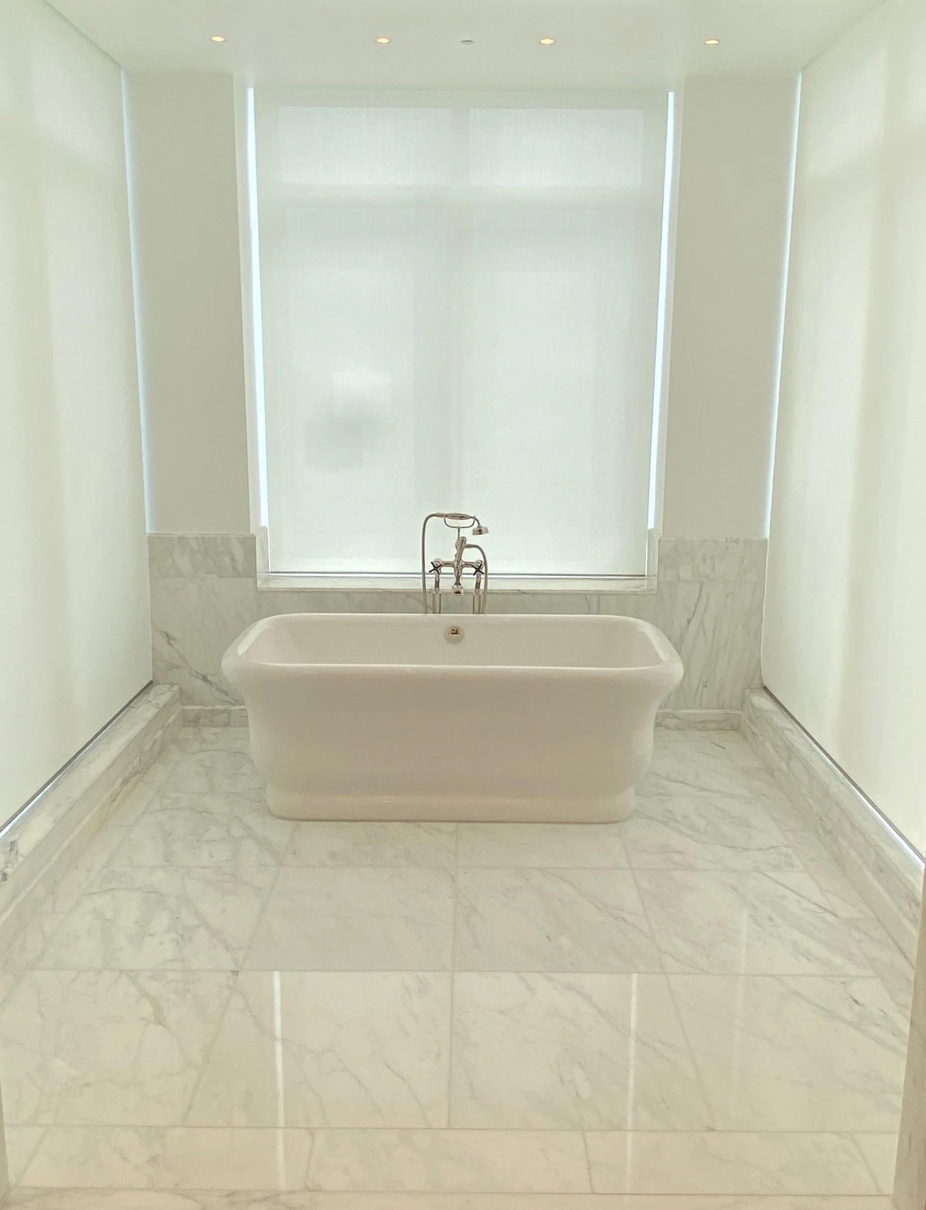 custom Lutron motorized roller shades for luxury bathroom in Marvin, NC home
